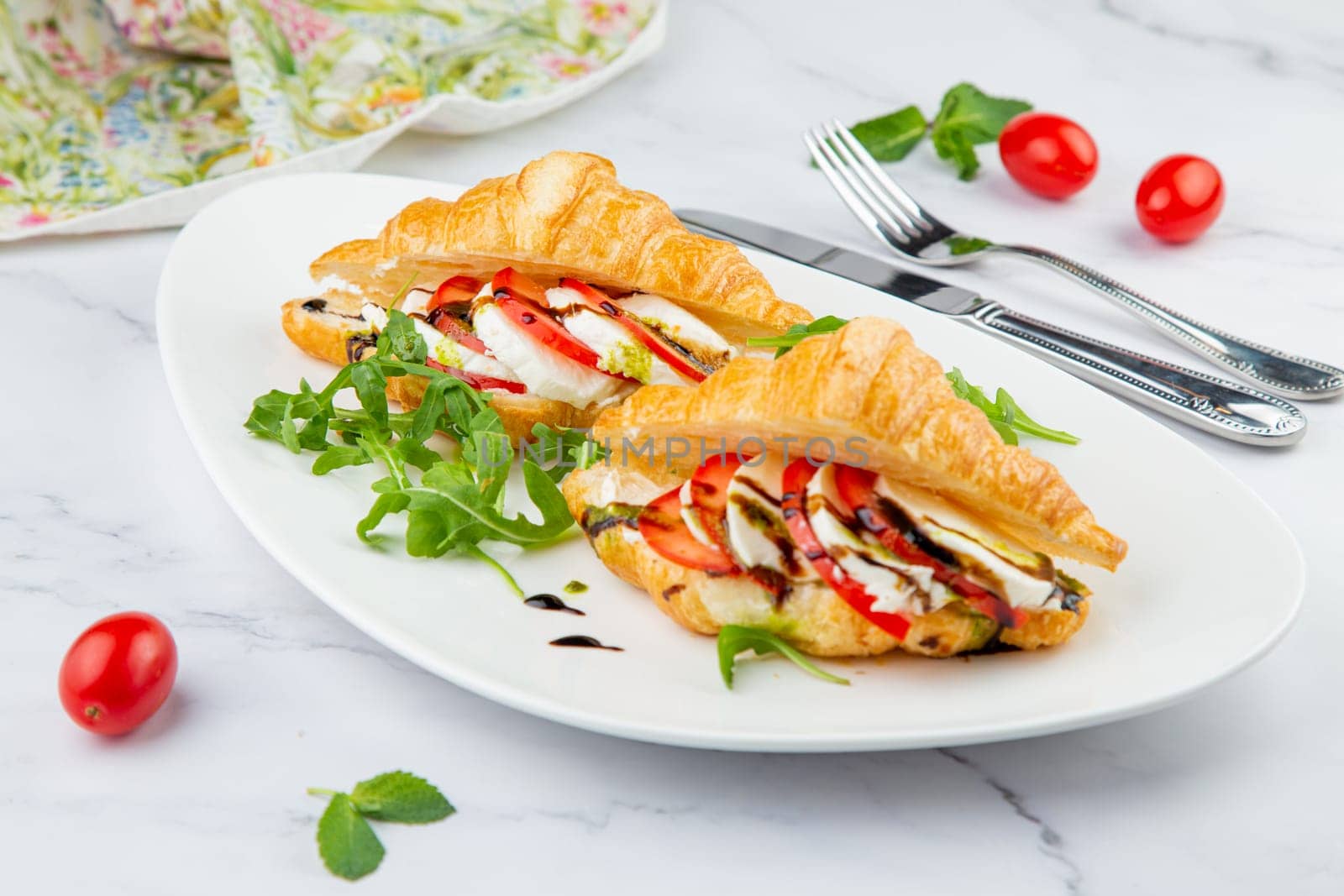 croissants with cheese, vegetables, cherry tomatoes and herbs by tewolf