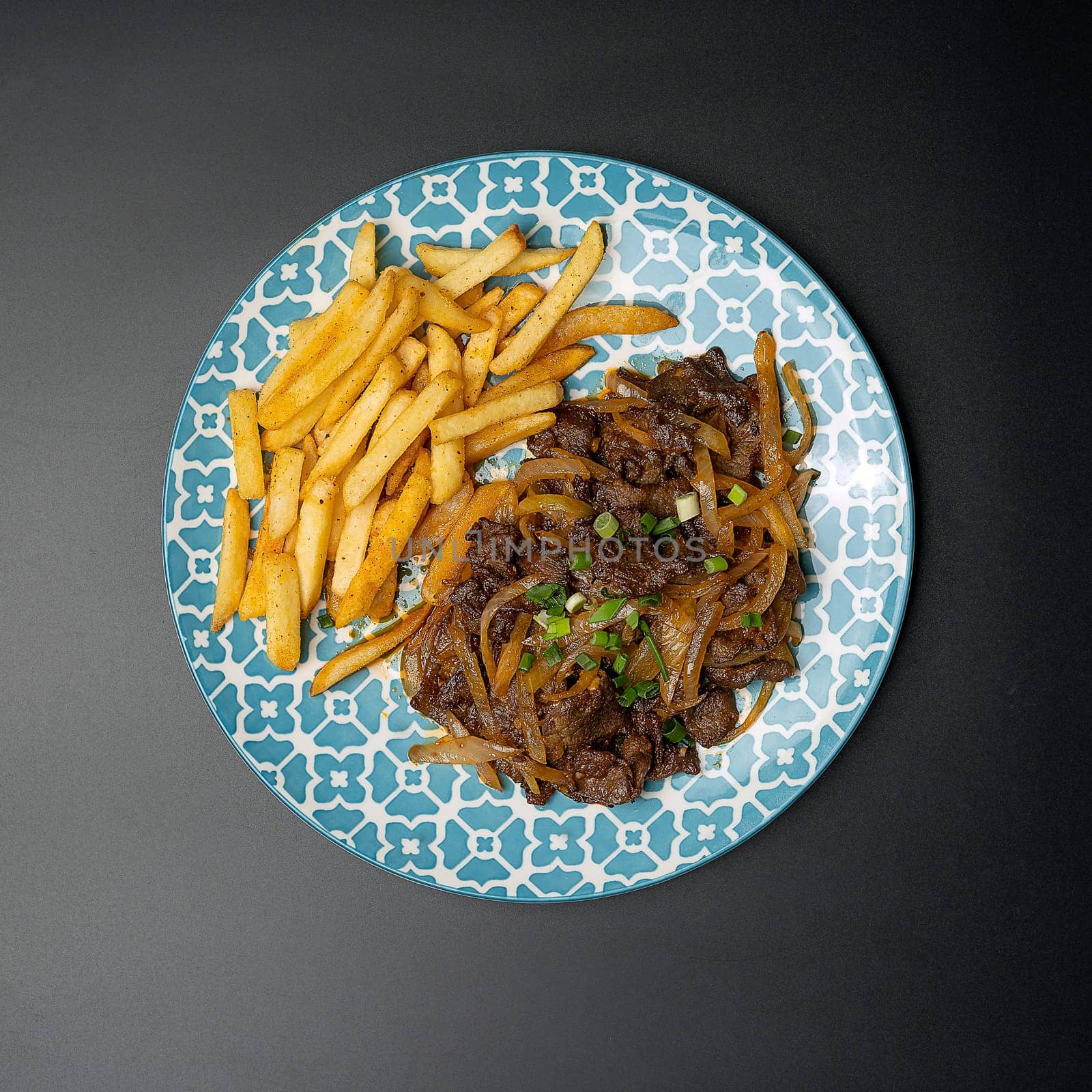 kebab cauldron with french fries on a dark background, top view by tewolf