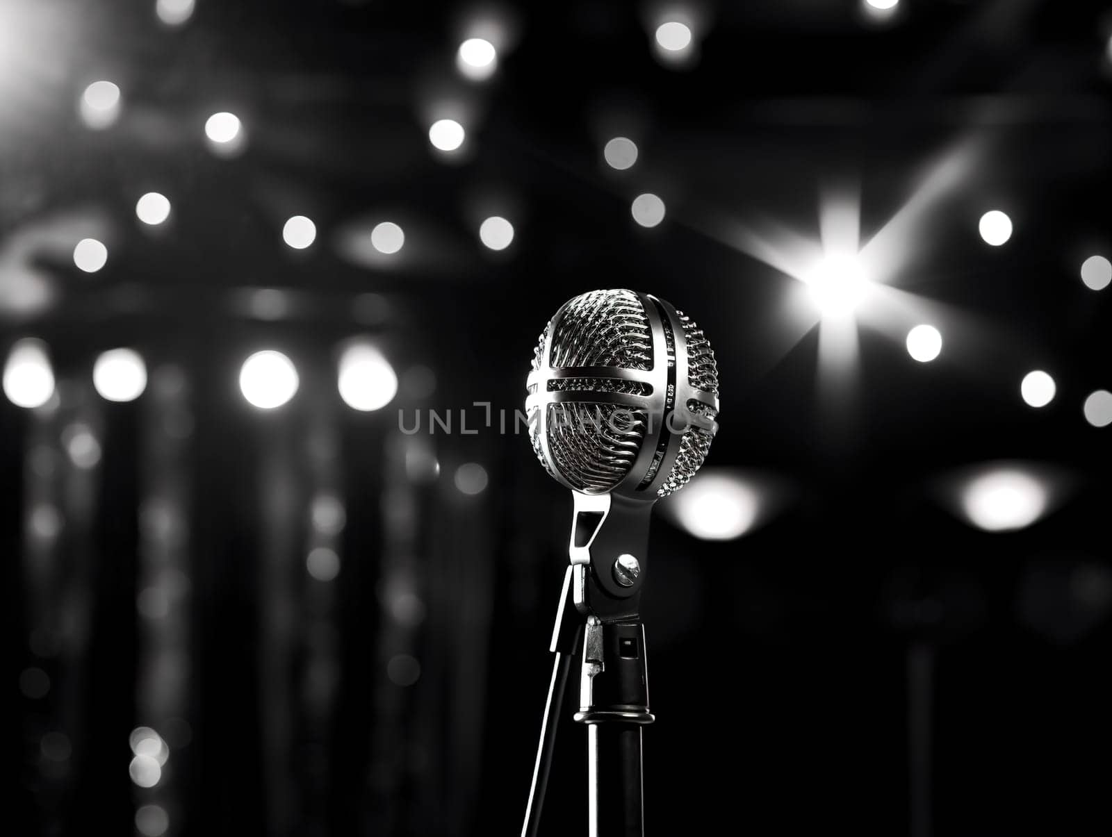 Detail to a microphone on the stage with glowing blurred background