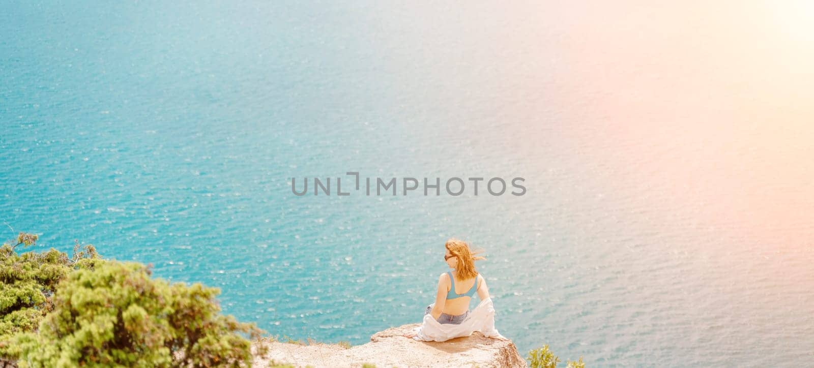Woman travel summer sea. Portrait of a happy woman on a background of beautiful sea. Rear view of a woman in a white shirt. Freedom and happiness by Matiunina