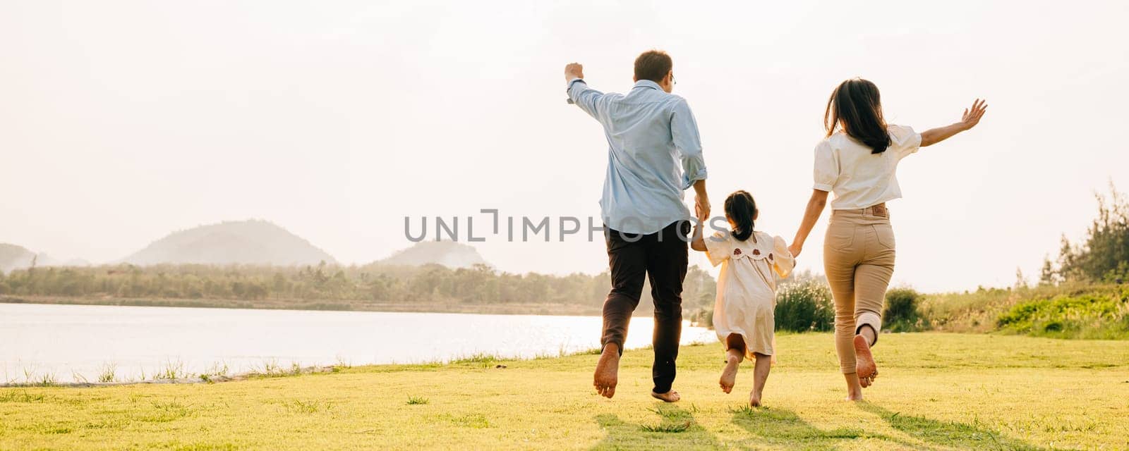 A happy couple running hand in hand on a sunny summer day, with a beautiful nature background, on a romantic journey together, family care