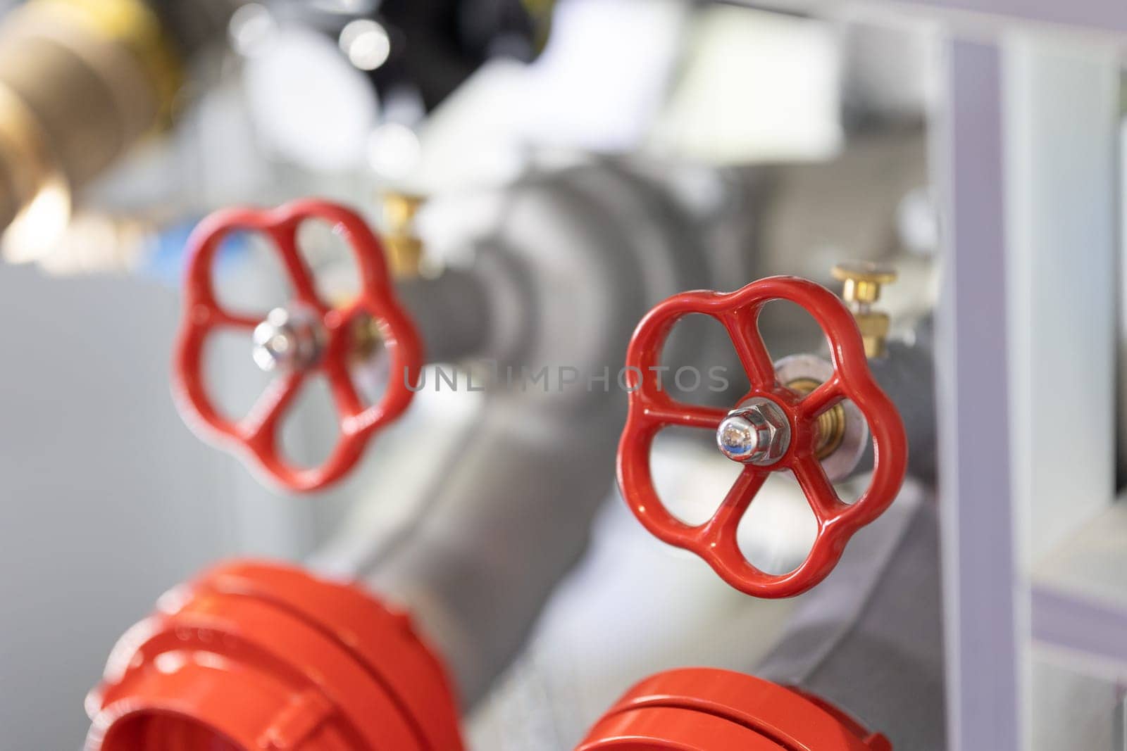 Close-up view of red metallic safety valves with handles.