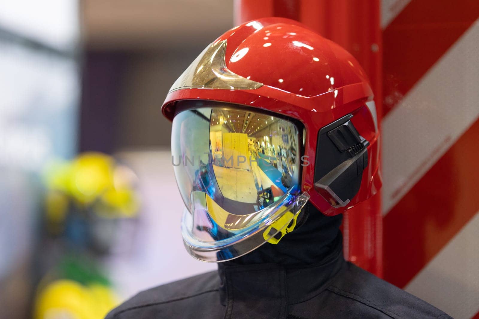 Close-up of a firefighter's helmet with a clear protective face shield.
