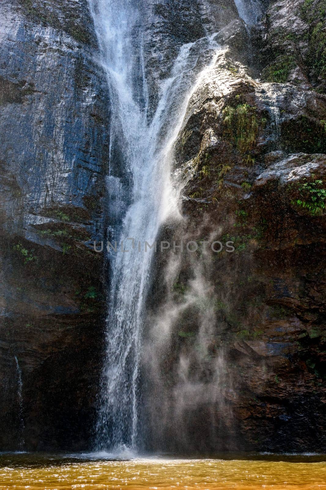 Waterfall water running down dark rocks by Fred_Pinheiro