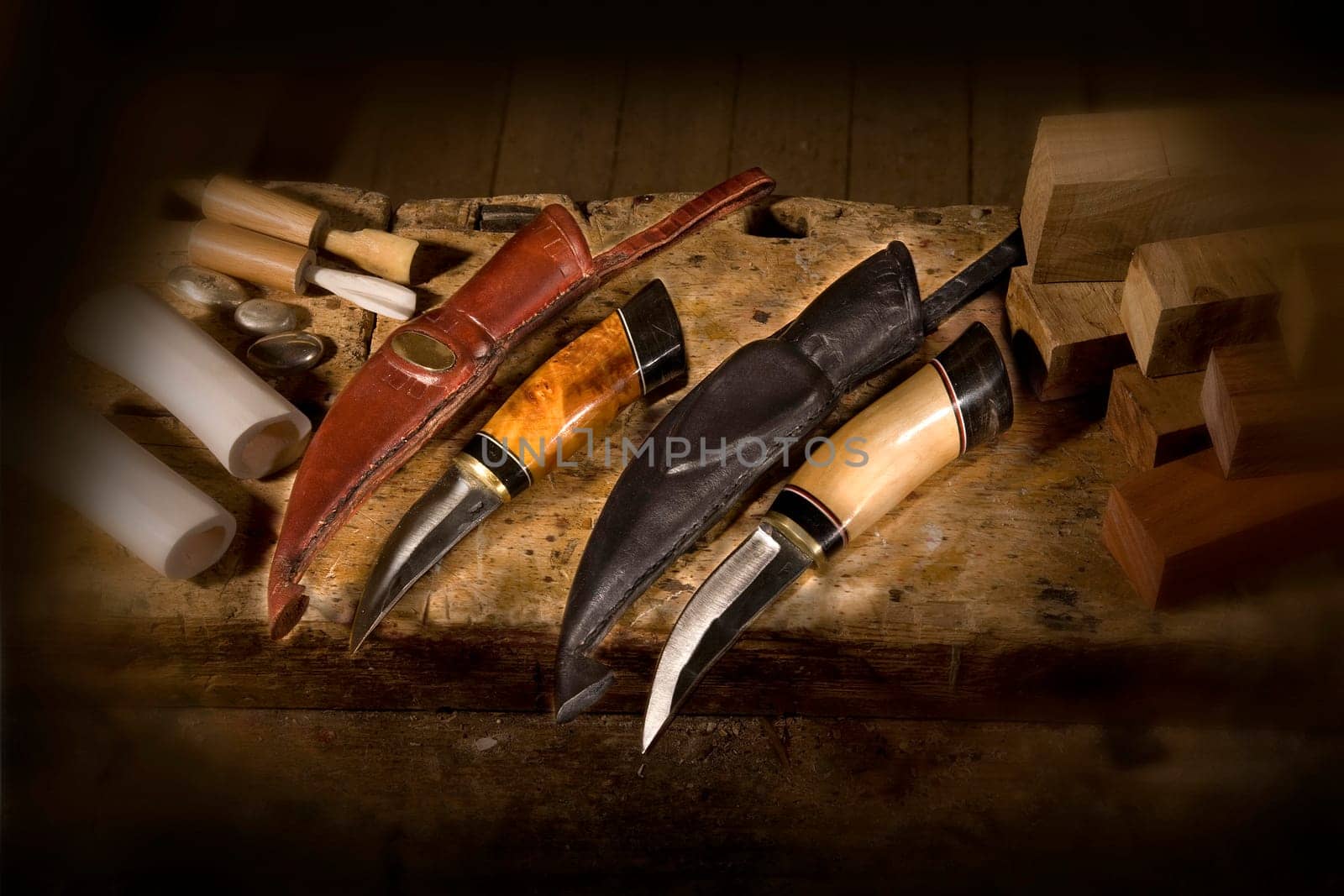 Handmade knife with a bone and wood handle and leather sheath.