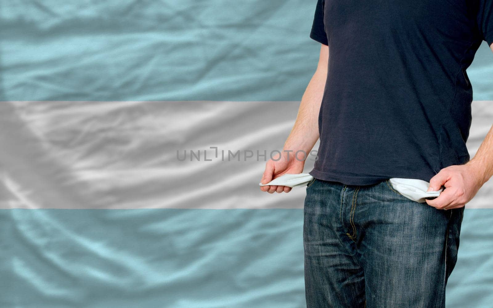 poor man showing empty pockets in front of arentina flag