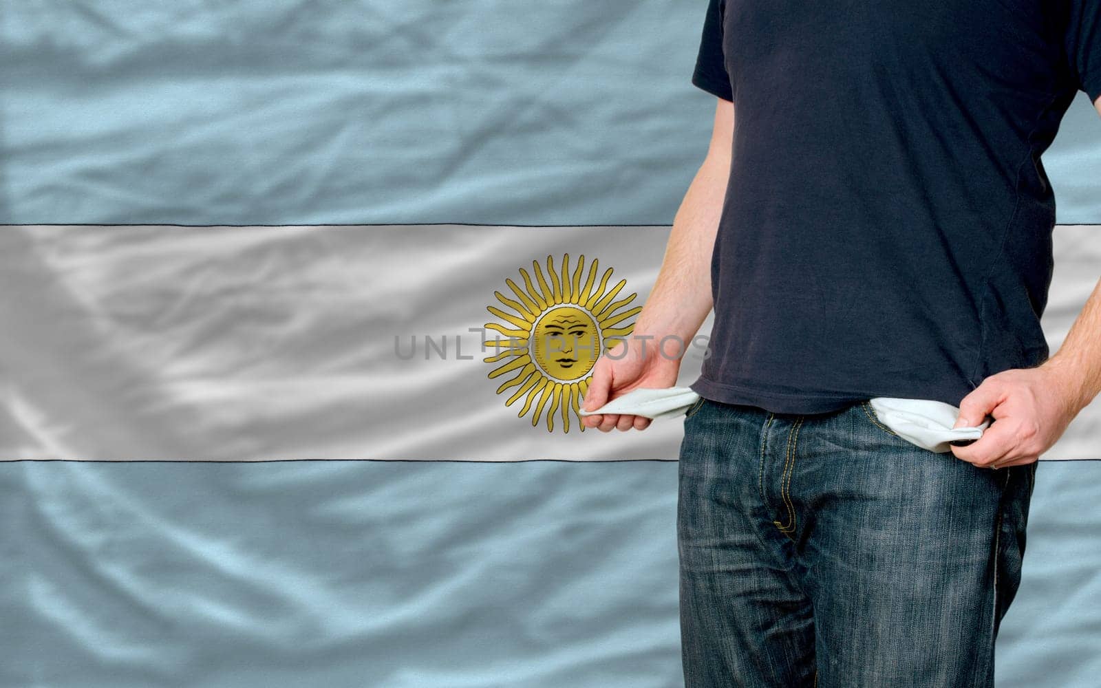 poor man showing empty pockets in front of arentina flag