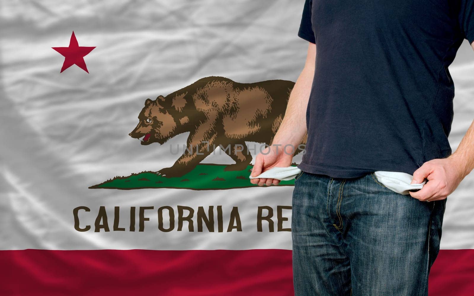 poor man showing empty pockets in front of california flag