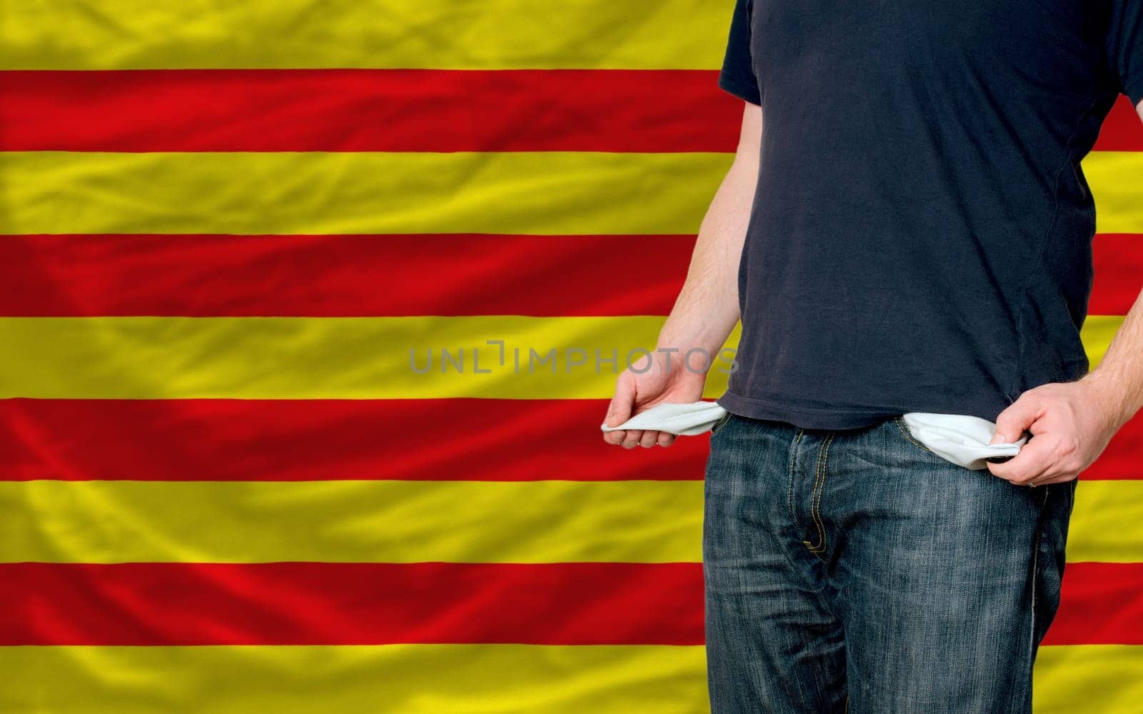 poor man showing empty pockets in front  of catalonia flag