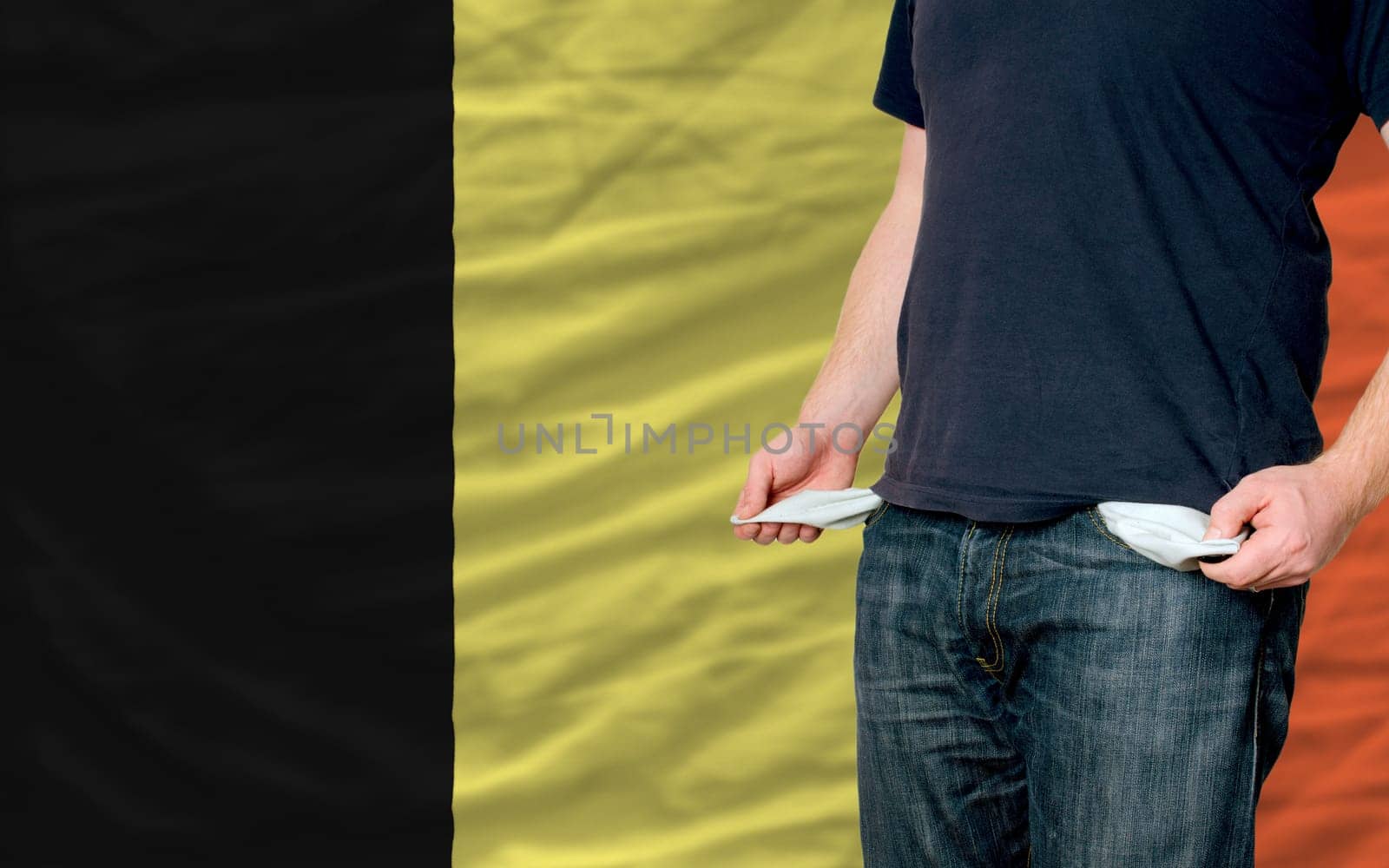 poor man showing empty pockets in front of belgium flag