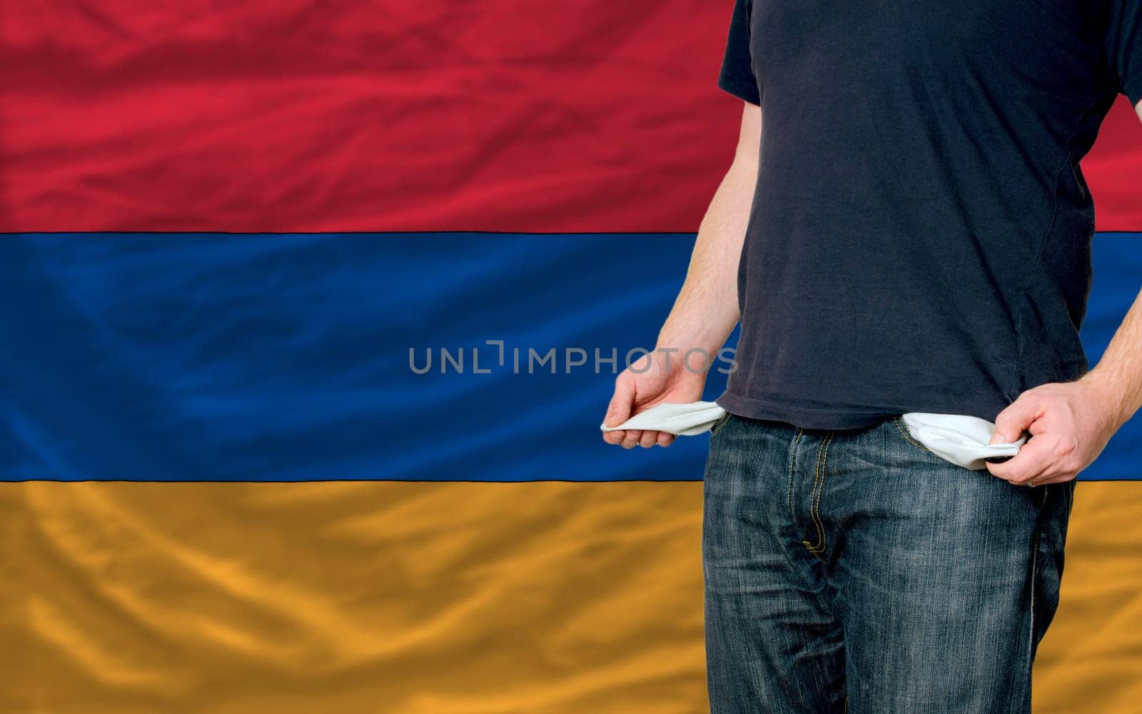 poor man showing empty pockets in front of armenia flag
