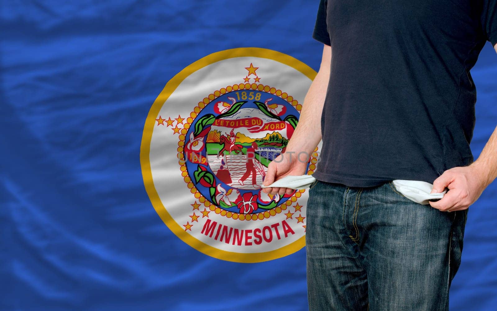 poor man showing empty pockets in front of american state of minnesota flag