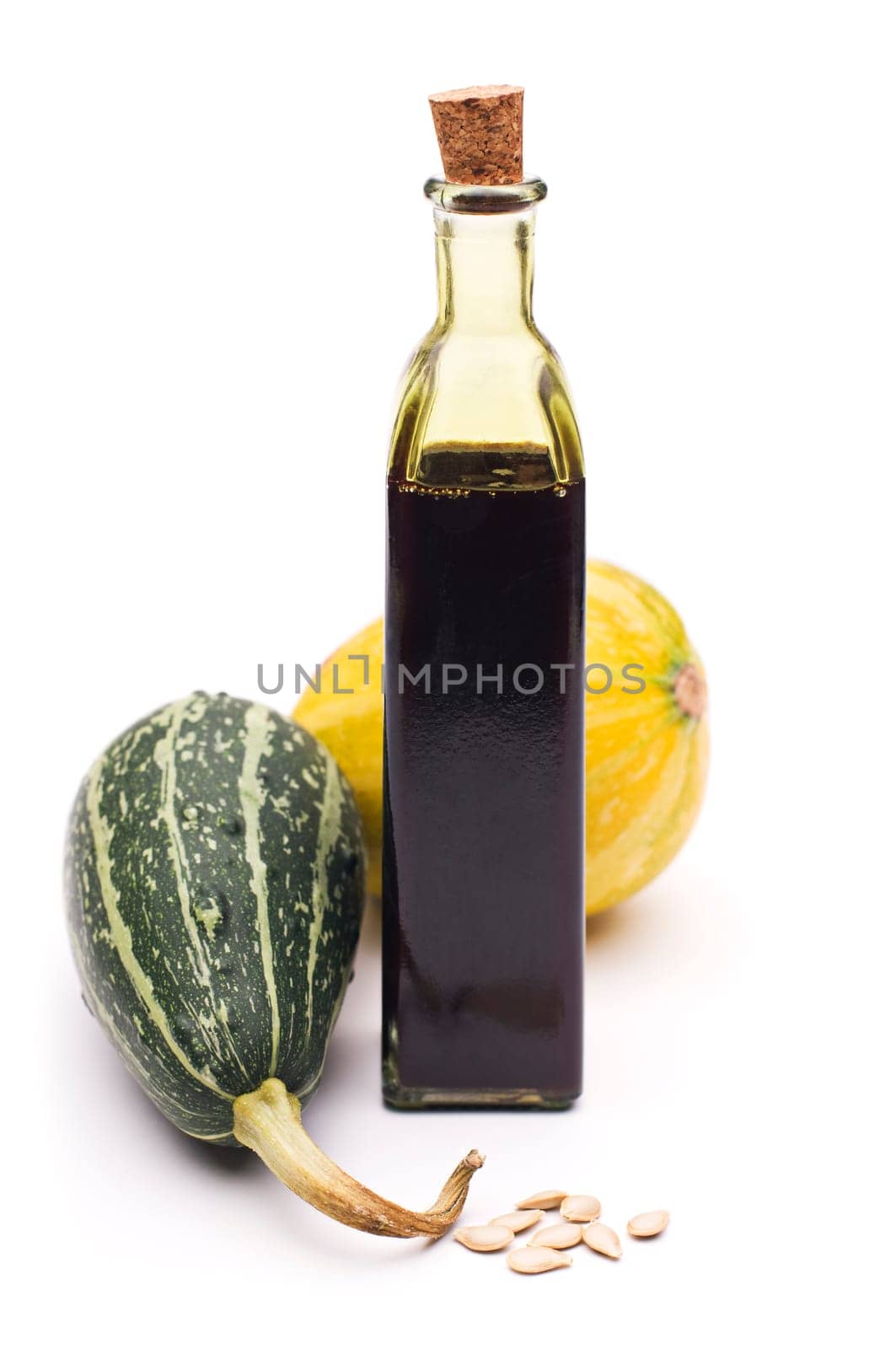 Fresh pumpkin oil close up isolated on white