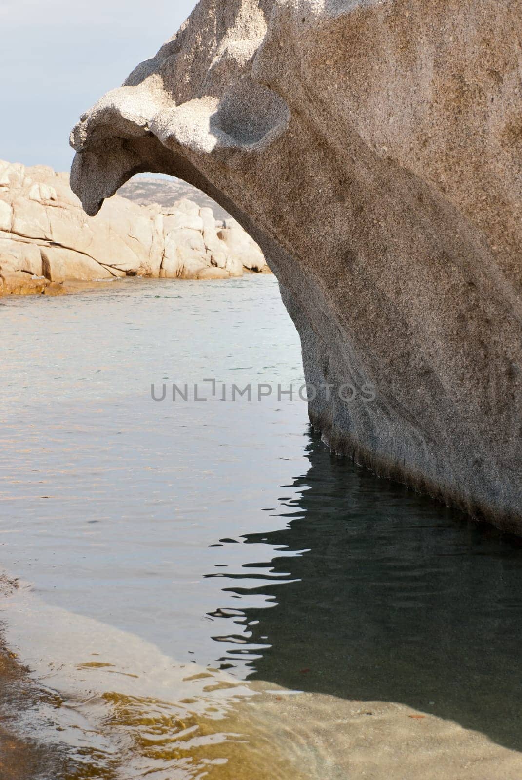 pink granite rock shaped like a wave in Sardinia