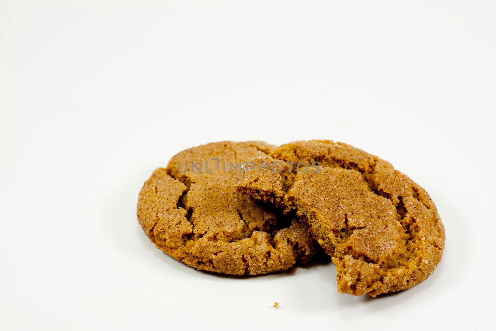 two ginger snap cookies with bite