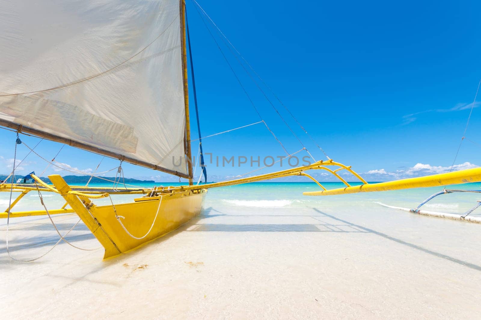 traditional paraw sailing boats on white beach on boracay island, Philippines