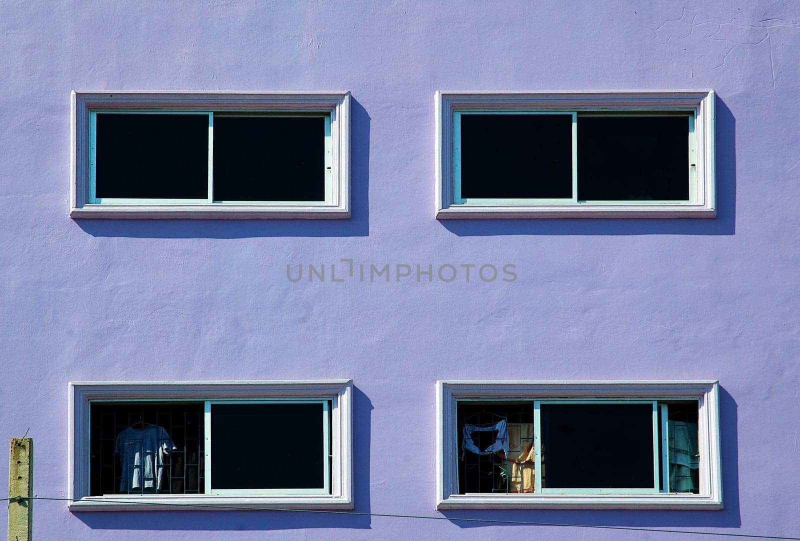 Artistic background. Windows on the purple wall with clear and right colors.