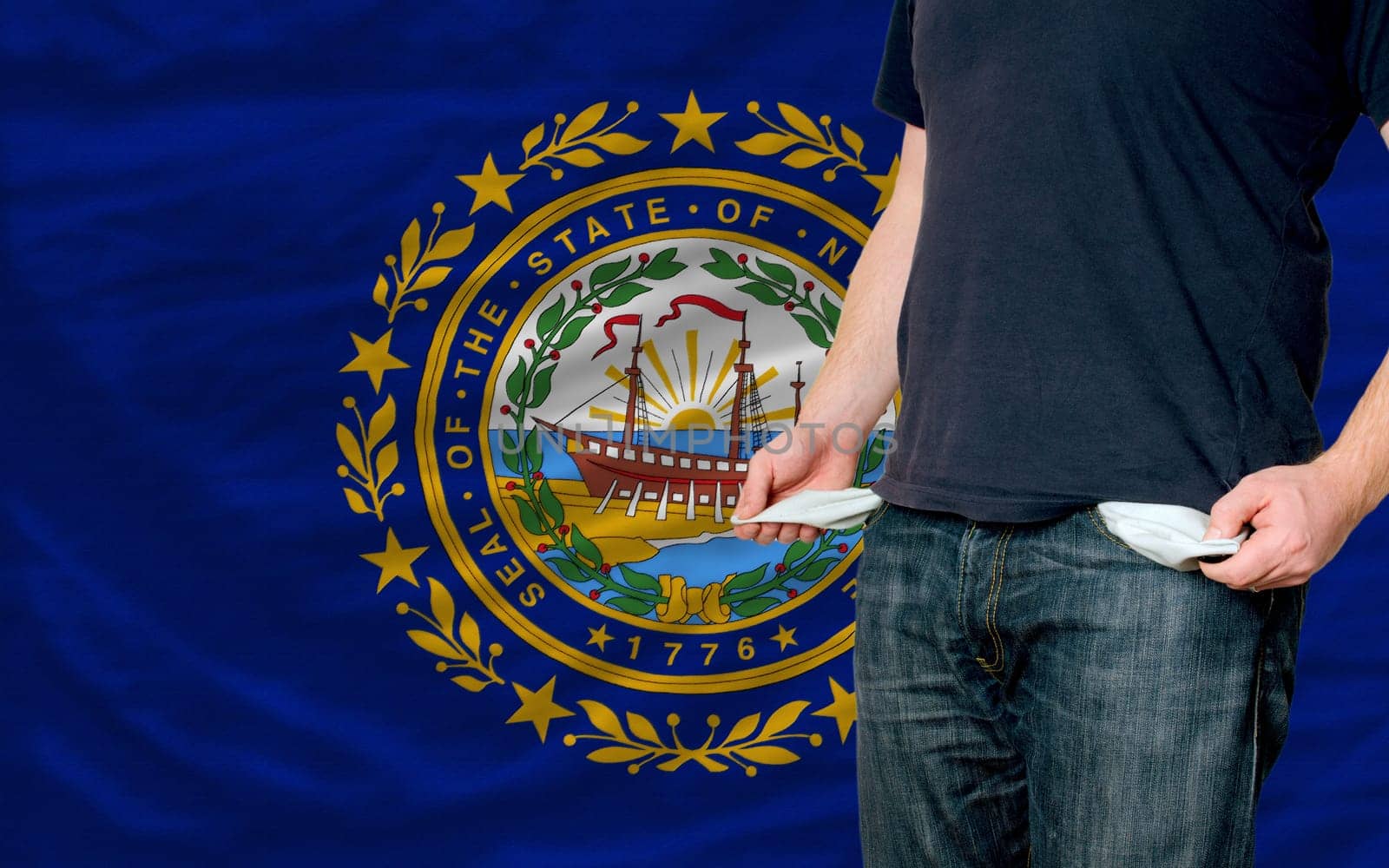 poor man showing empty pockets in front of american state of new hampshire flag