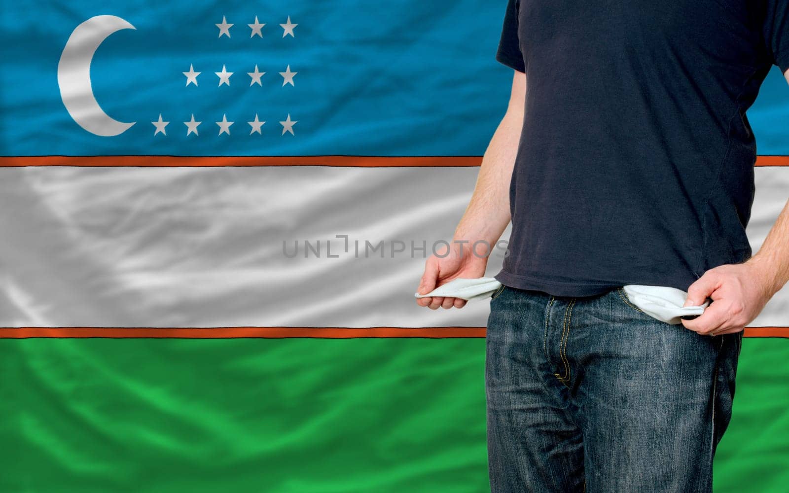 poor man showing empty pockets in front of uzbekistan flag
