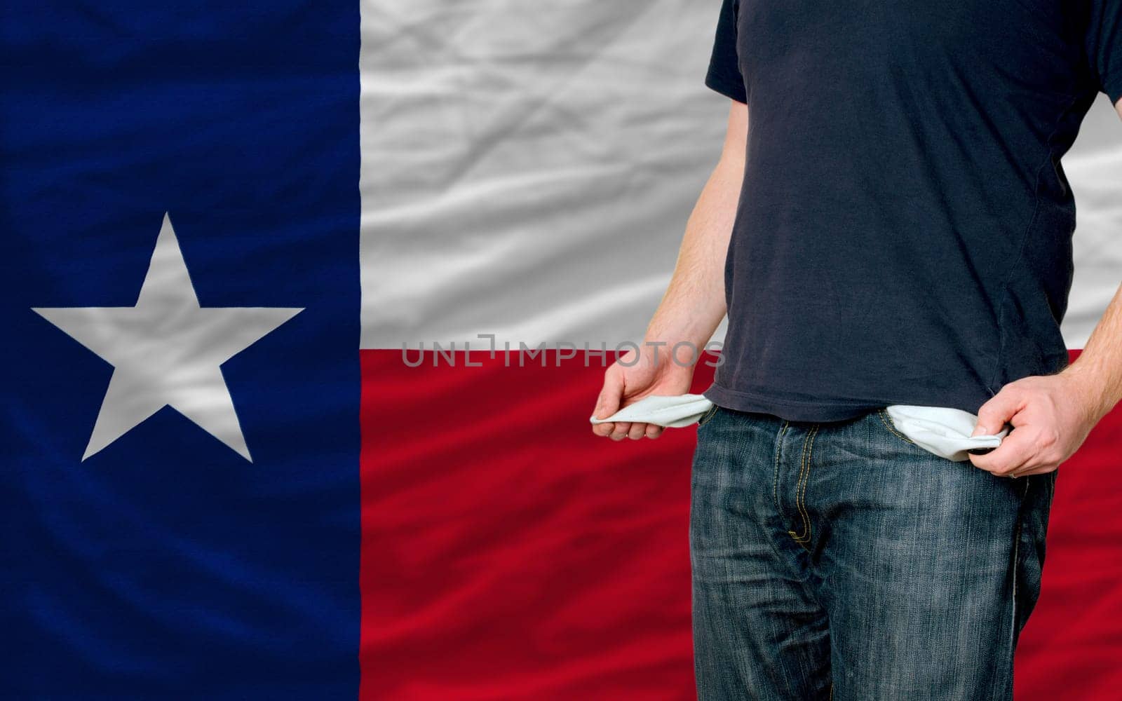 poor man showing empty pockets in front of american state of texas flag