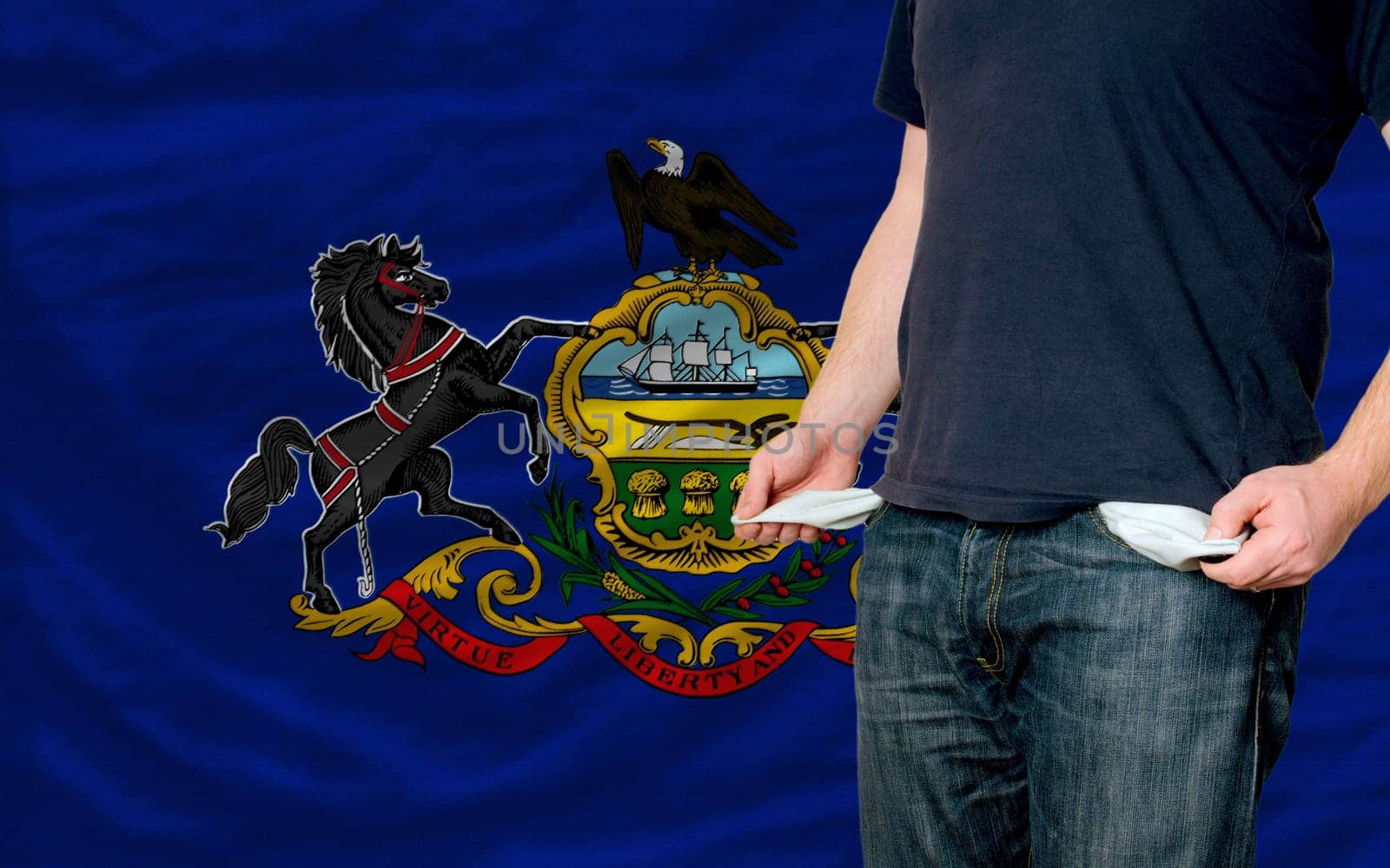 poor man showing empty pockets in front of american state of pennsylvania flag