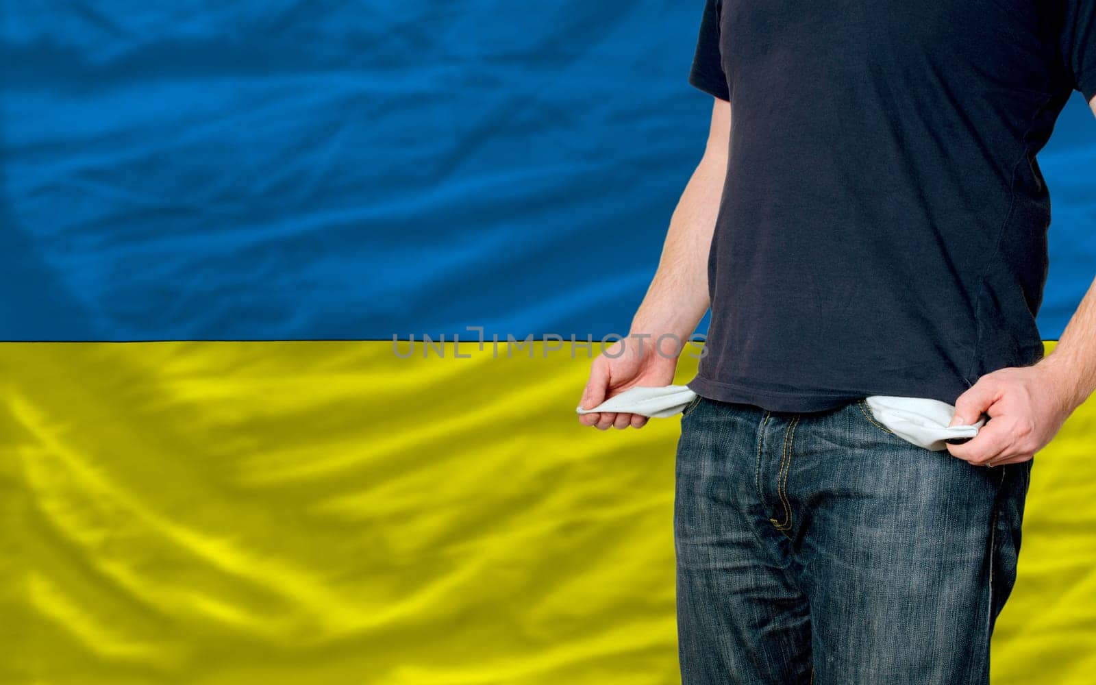 poor man showing empty pockets in front of ukraine flag