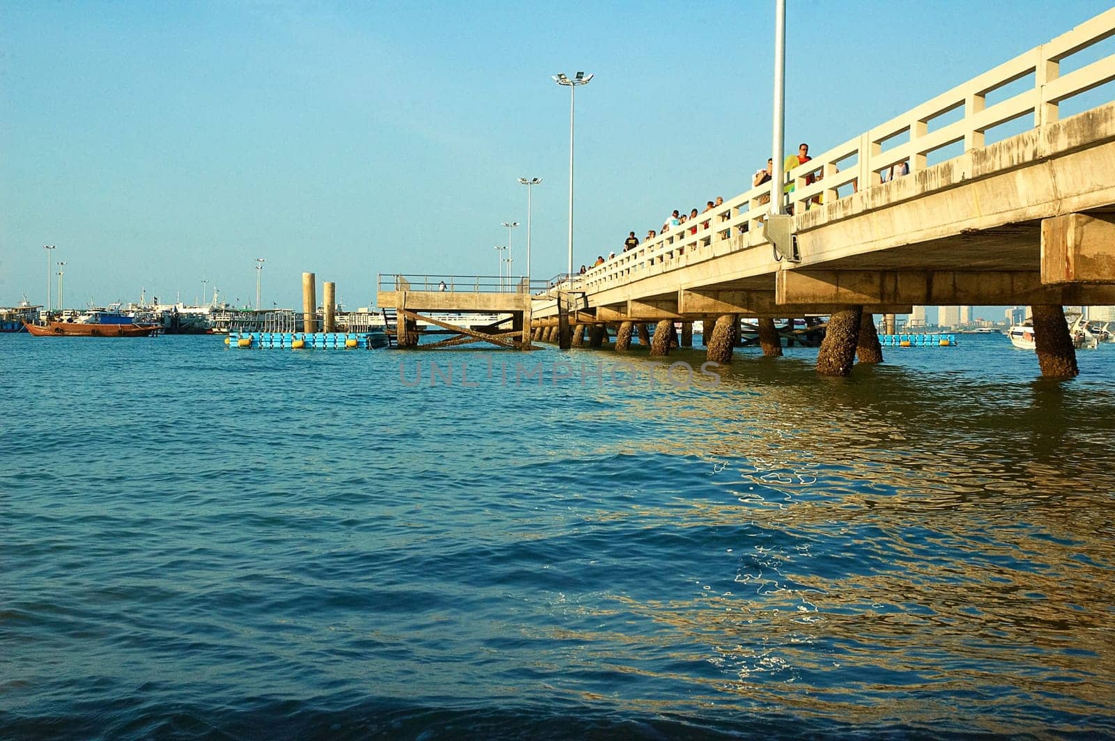 Pier, boats, buildings, beach  modern seacoast urban landscape.