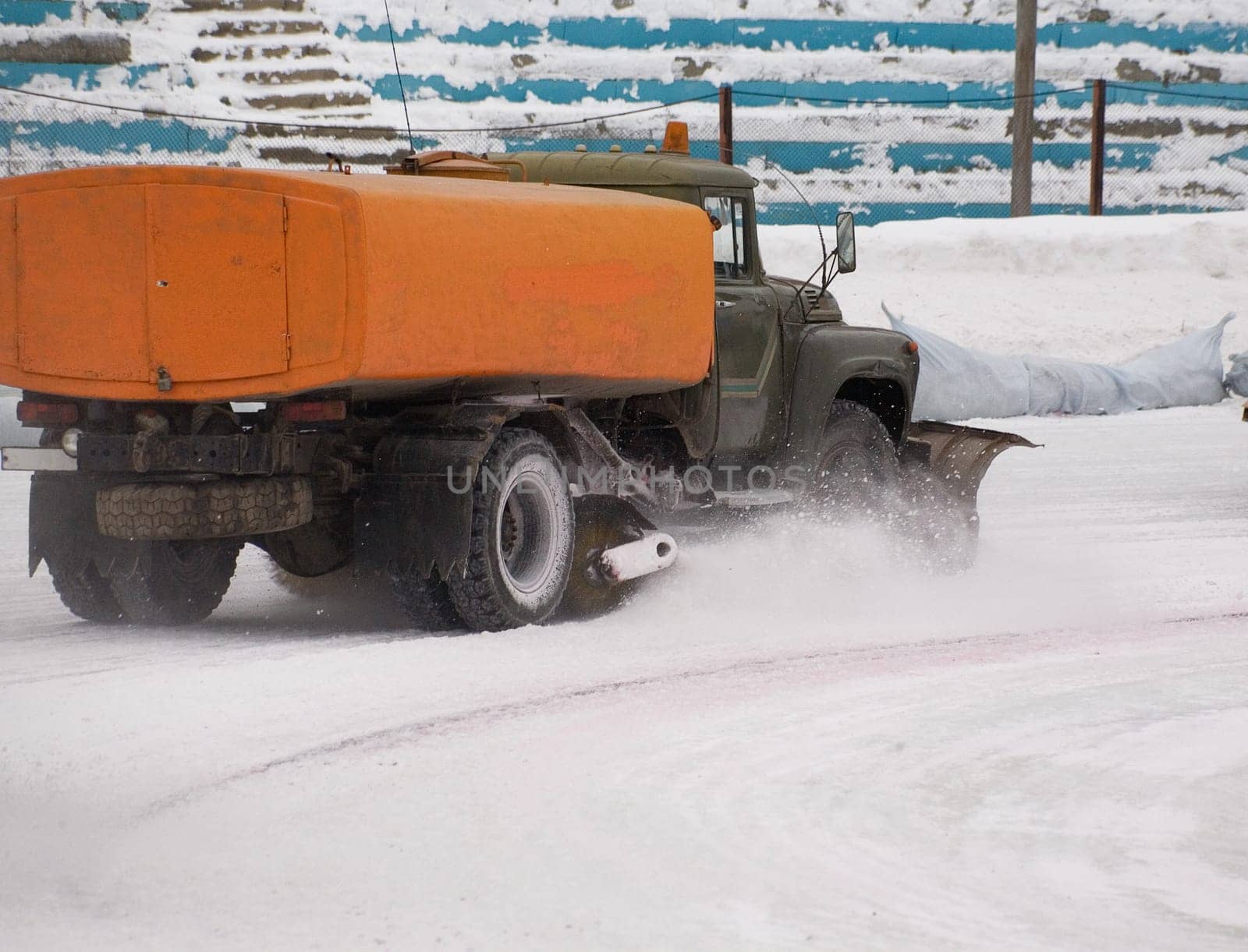 Snow fighter. Ice stadium. Before ice speedway race.