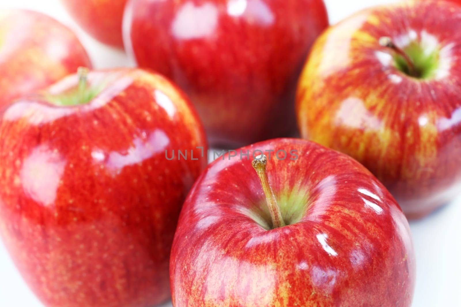 Delicious red aplles on white background