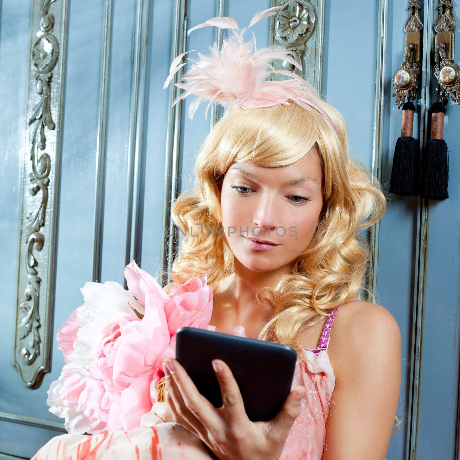 blond fashion princess woman reading ebook tablet with retro spring pink dress