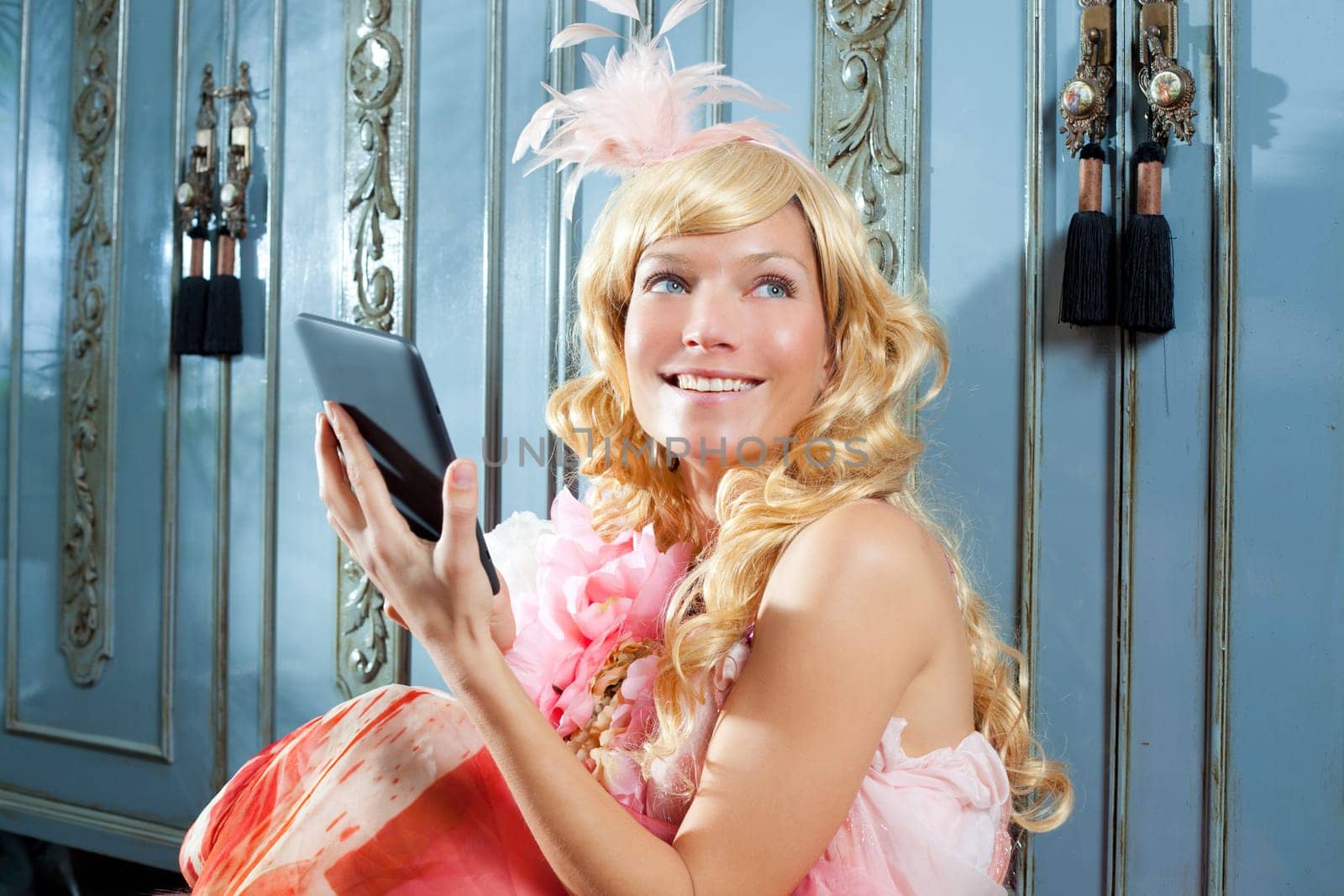blond fashion princess woman reading ebook tablet with retro spring pink dress
