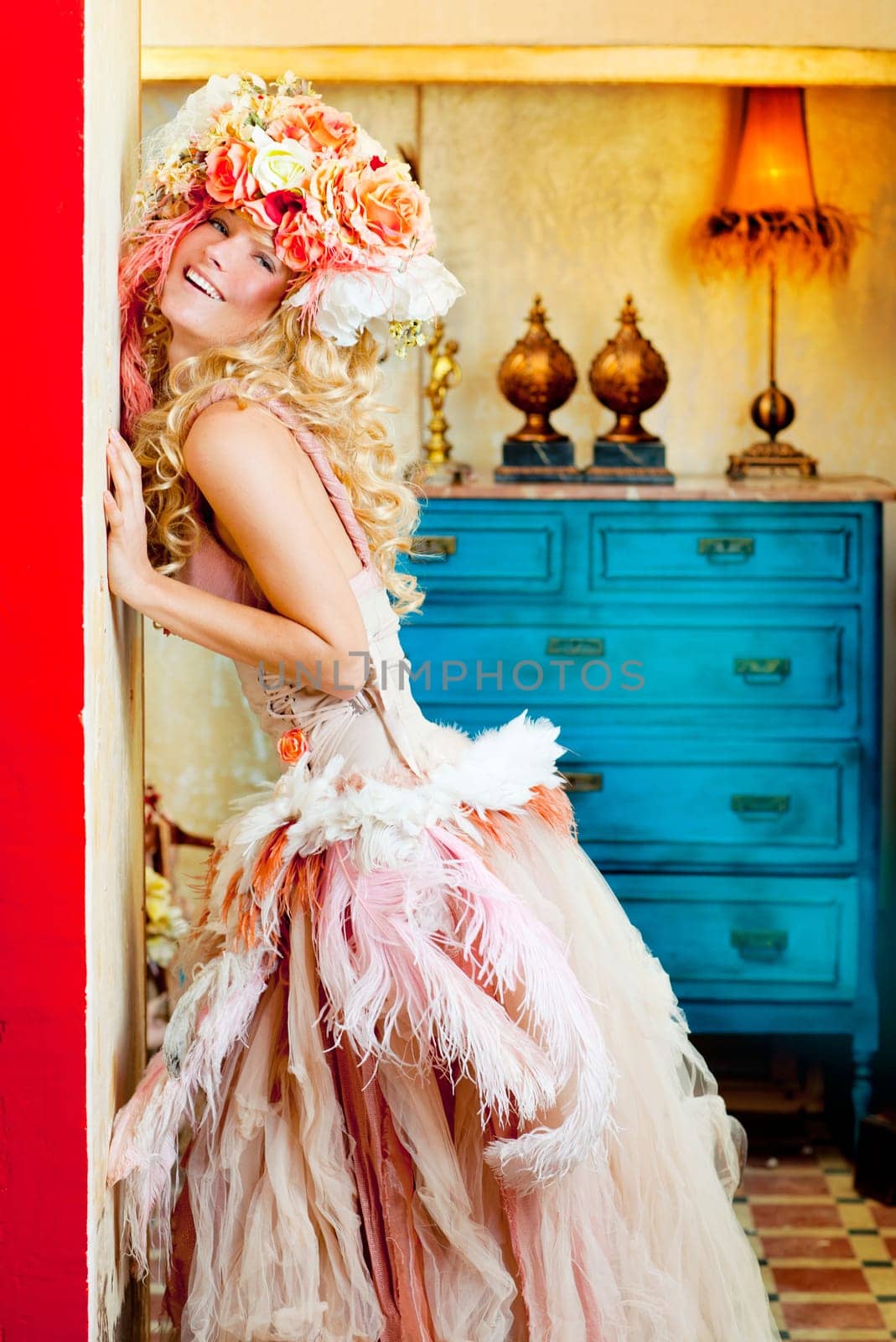 baroque fashion blonde woman in grunge interior with spring flowers hat