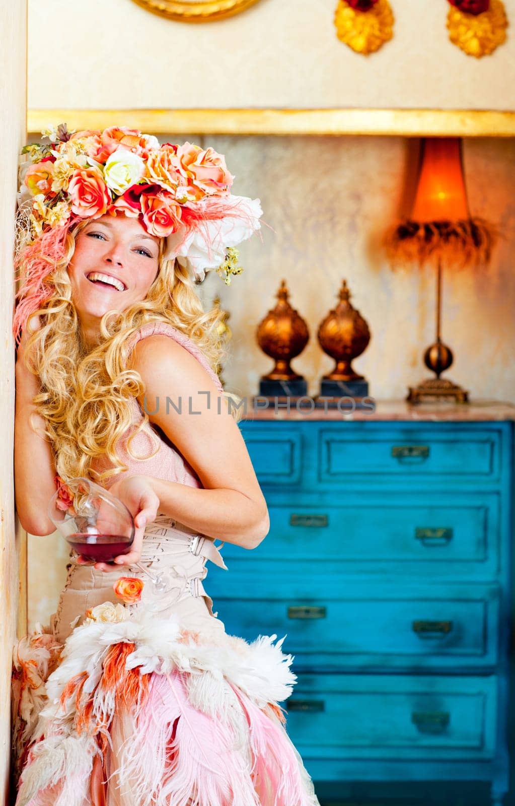 baroque fashion blond womand drinking red wine in grunge house