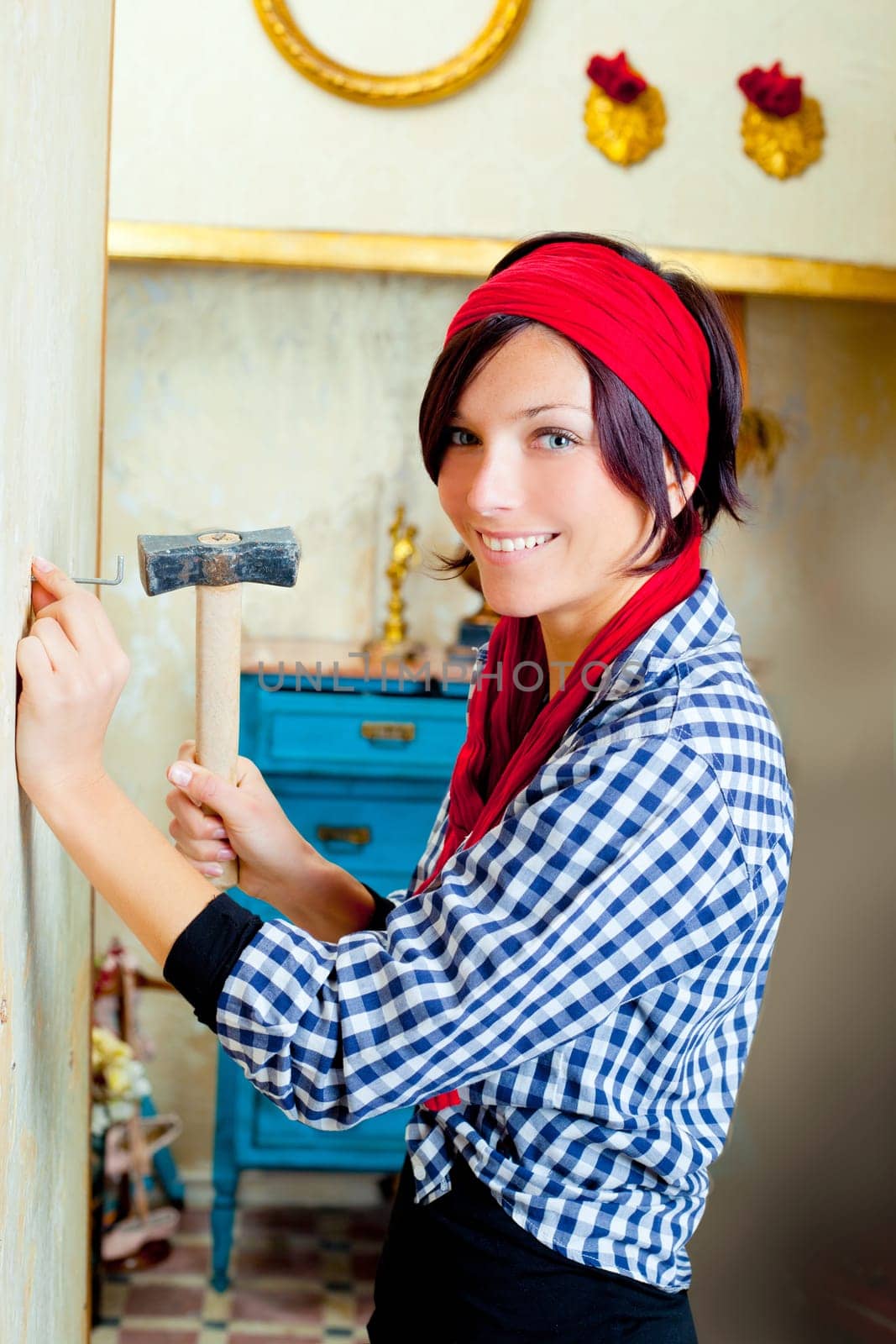 Diy fashion woman with nail and hammer on grunge house