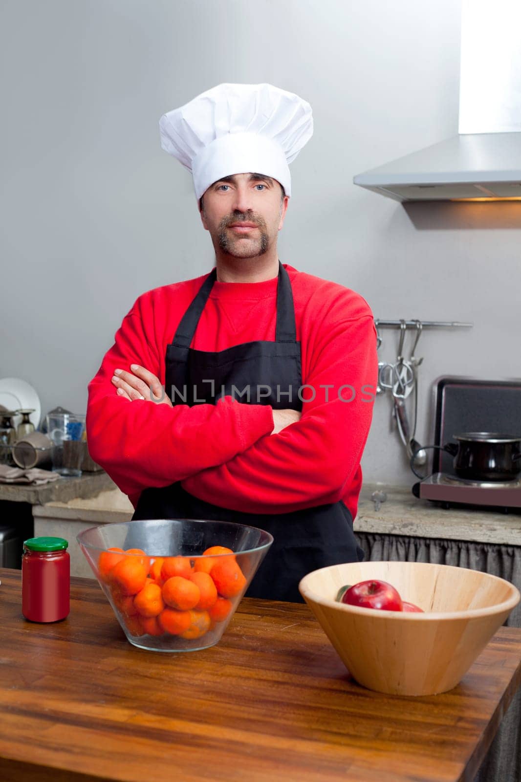 Chef man portrait with mustache in black and red on the kitchen
