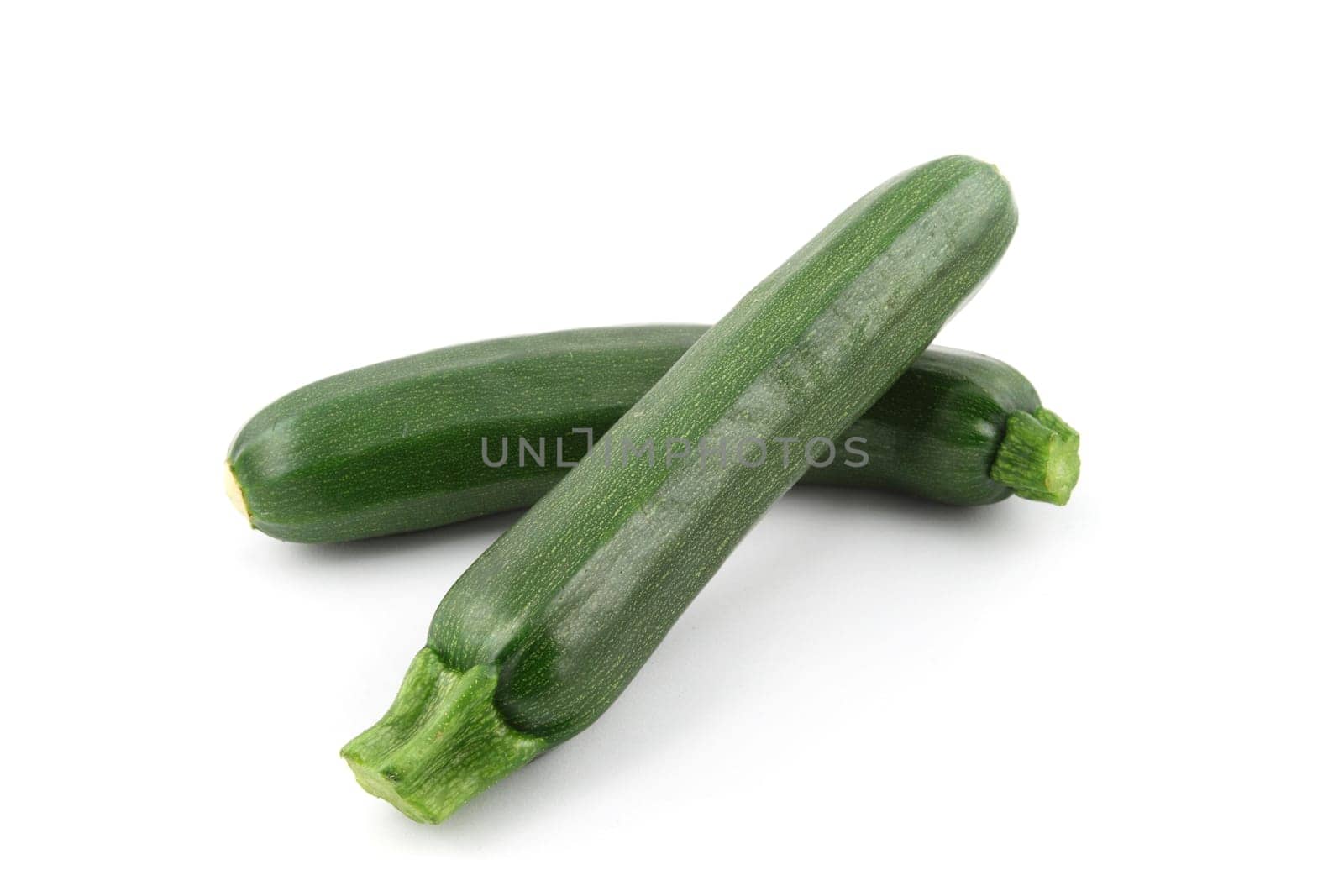 details of a fresh zucchini isolated on white on salad