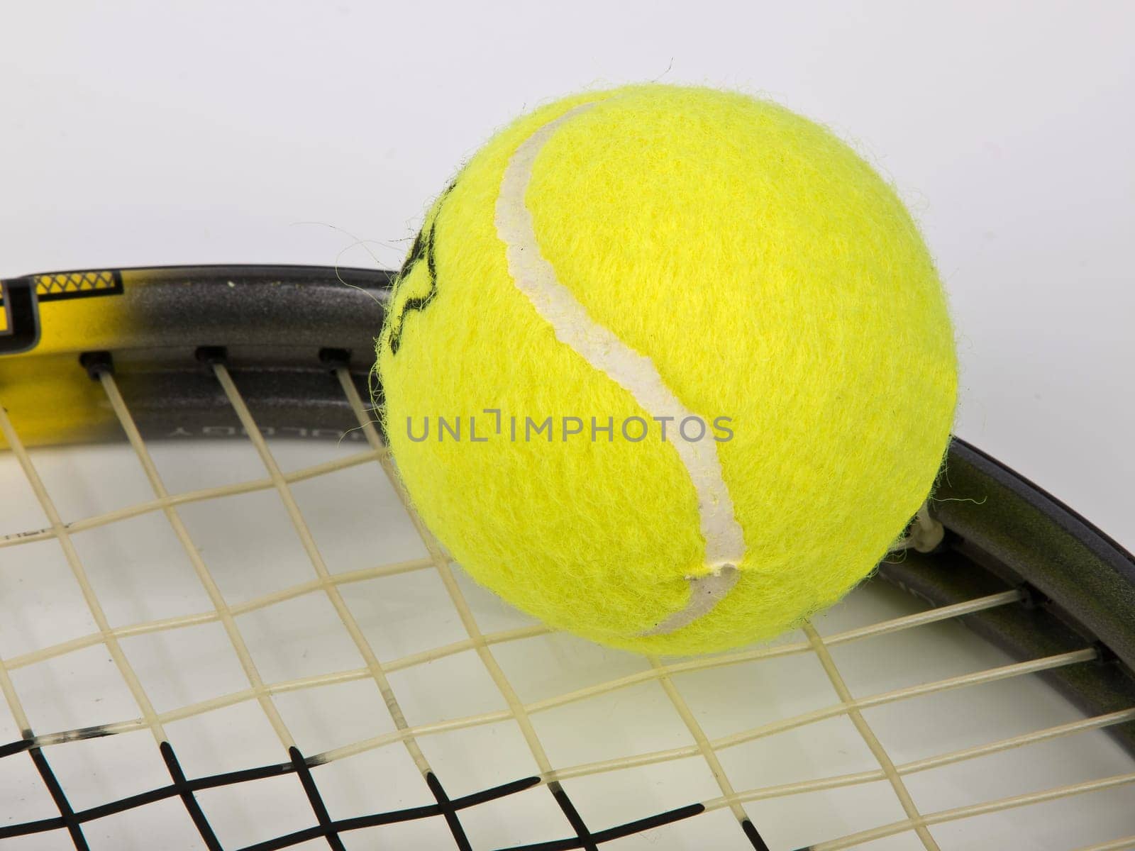 tennis racket with yellow ball