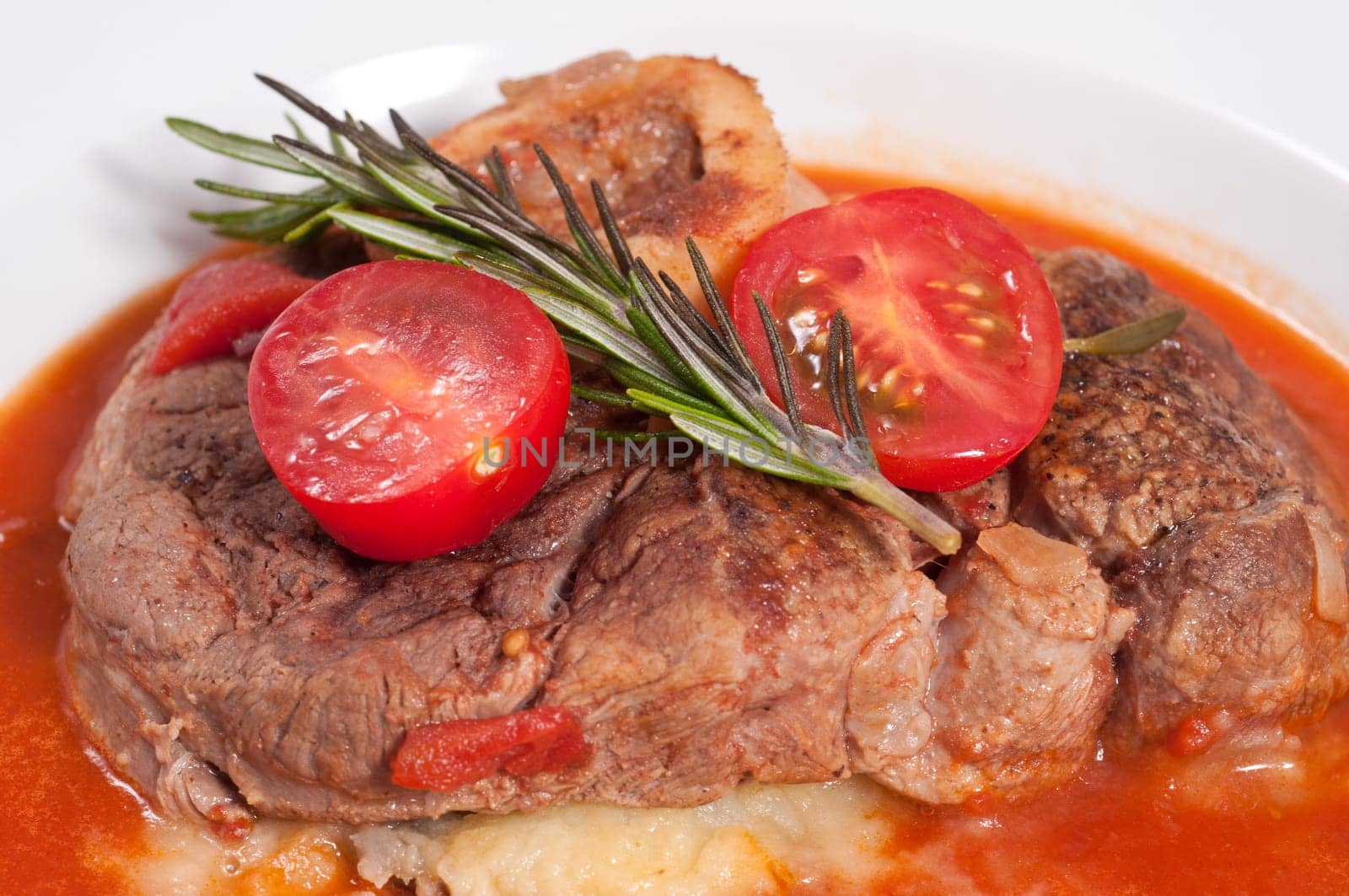 Braised veal shanks with rosemary and tomatoes and tomato sauce