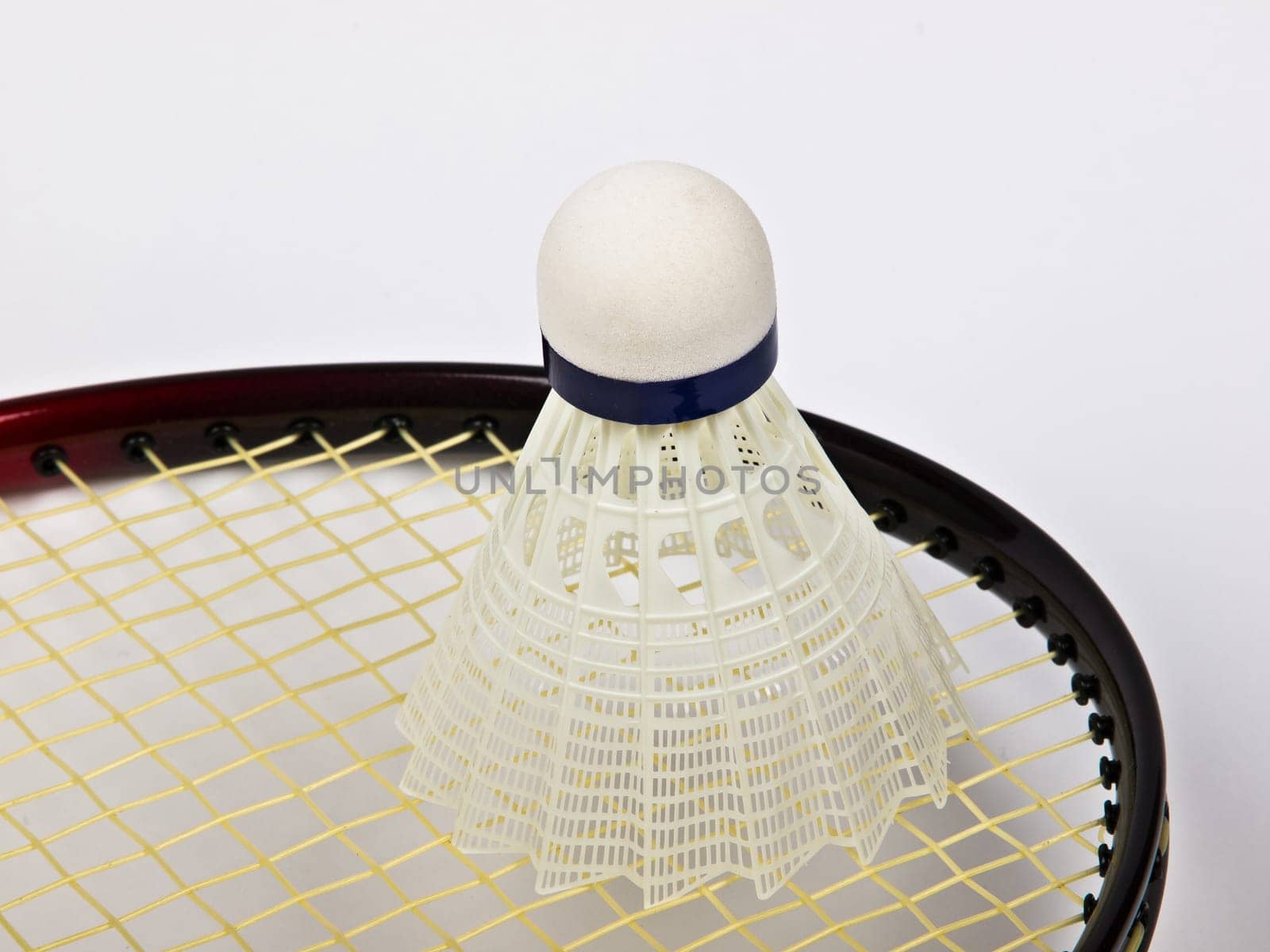 red badminton racquet and shuttlecock