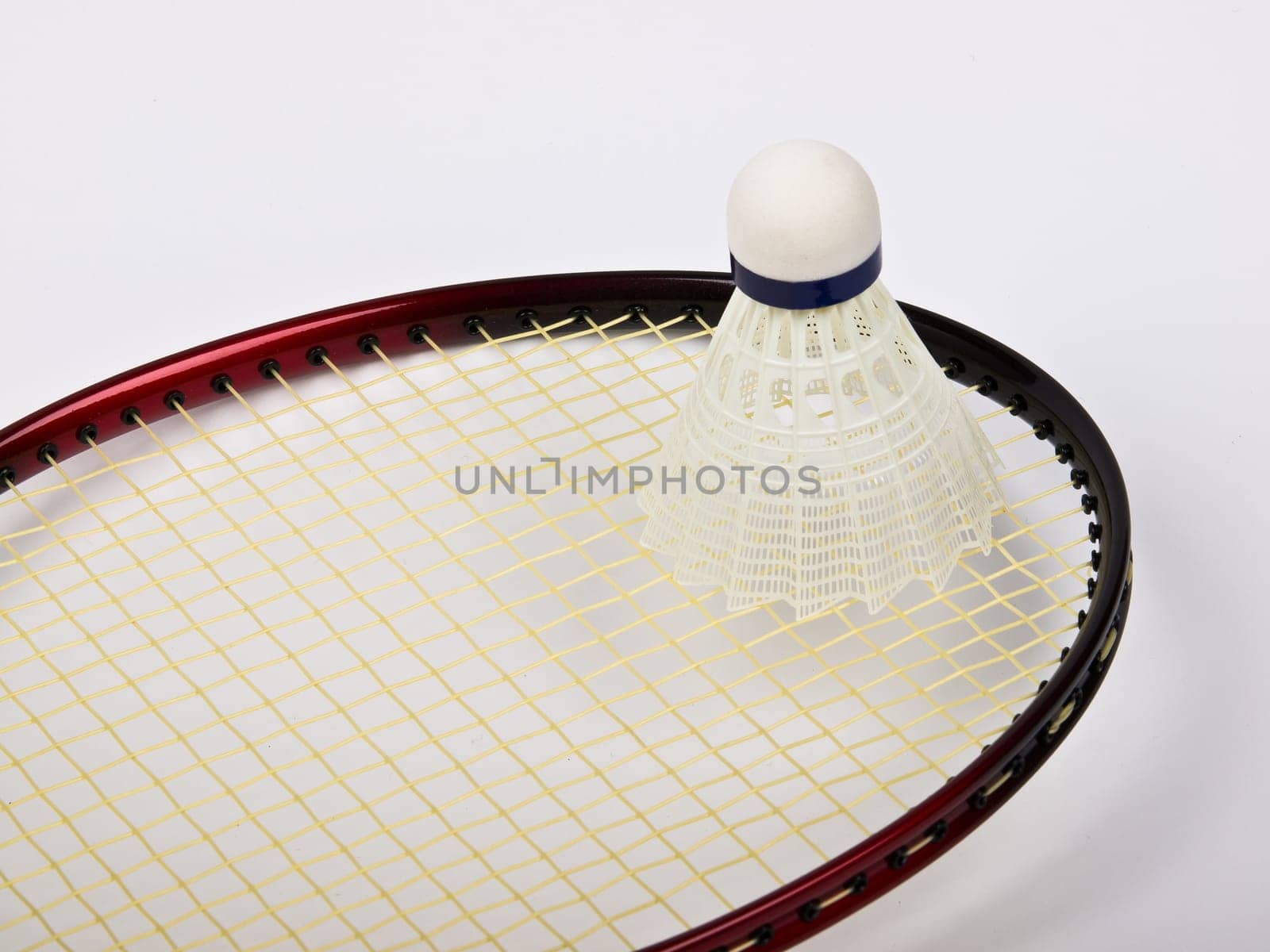 red badminton racquet and shuttlecock