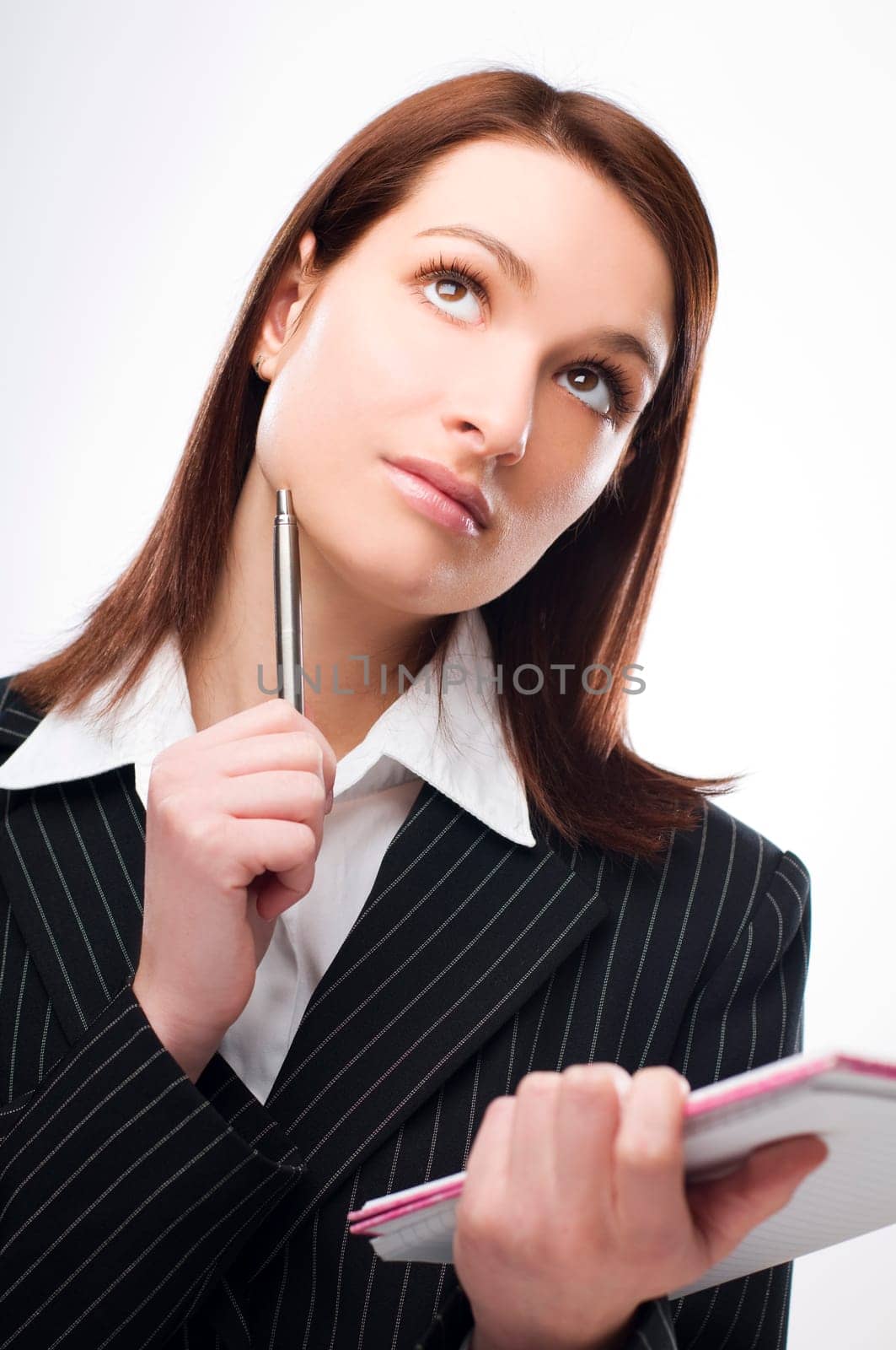 Young brunette woman thinking close up shoot