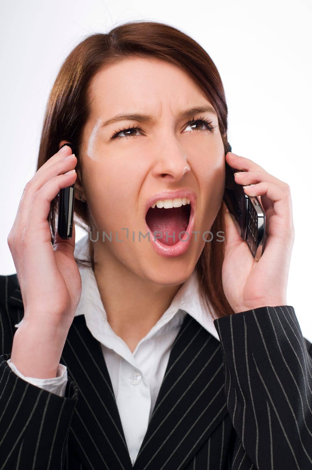 Young upset business woman talking on the mobile phone