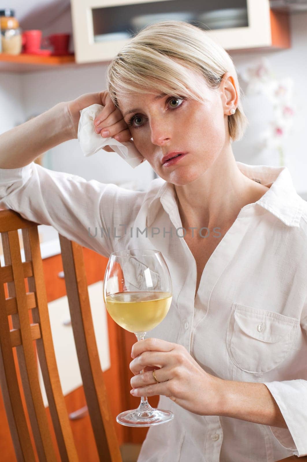 Sad beautiful young woman drinking wine close up