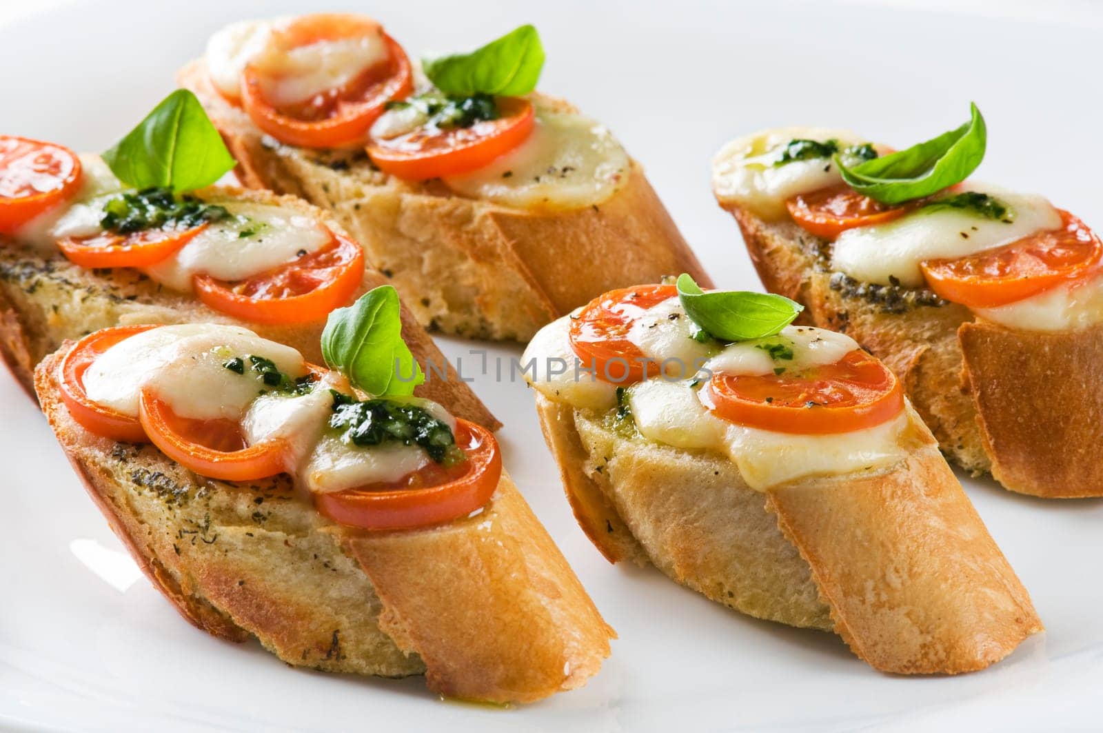 Tomato, mozzarella and basil sandwich close up