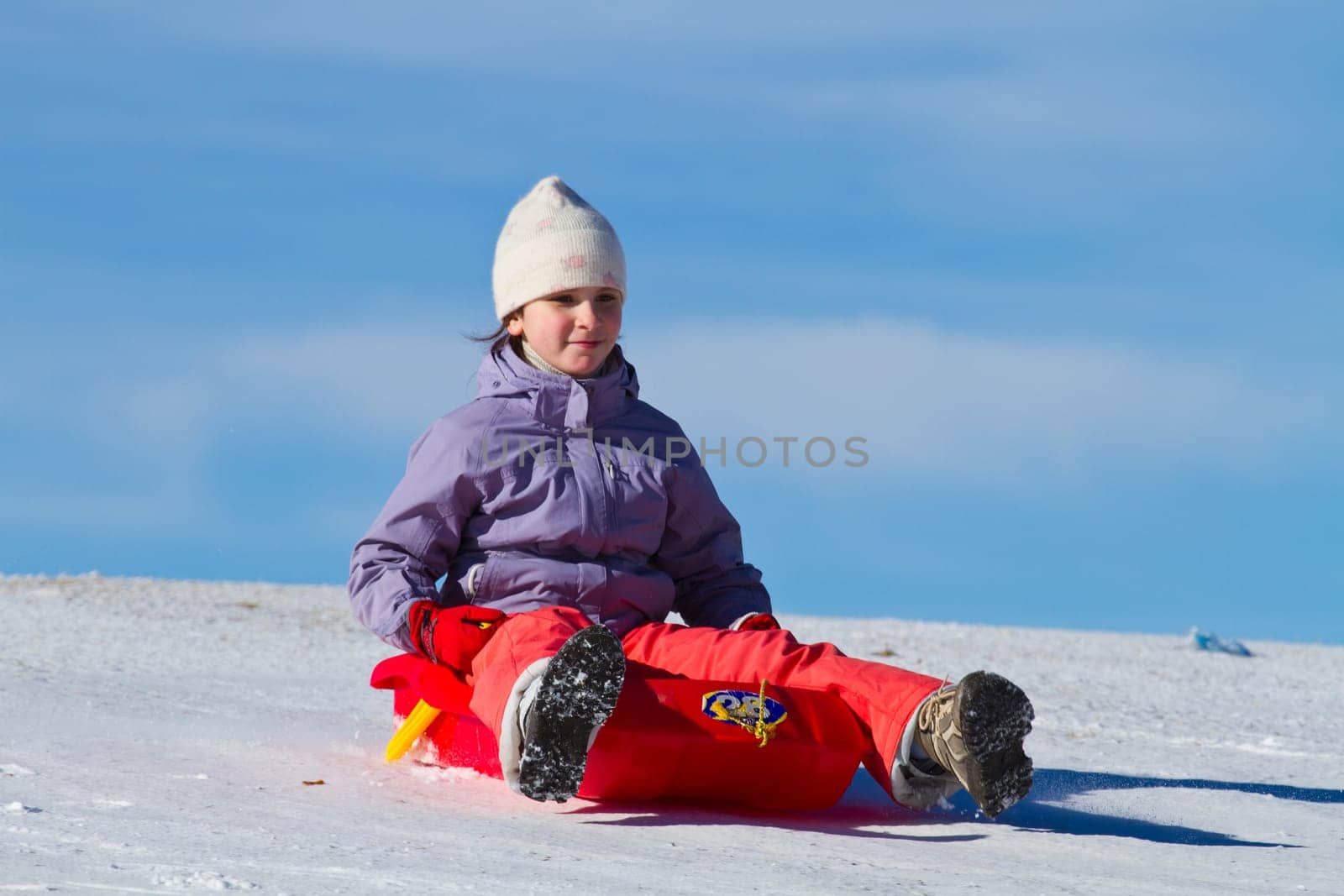 A girl sliding in the snow