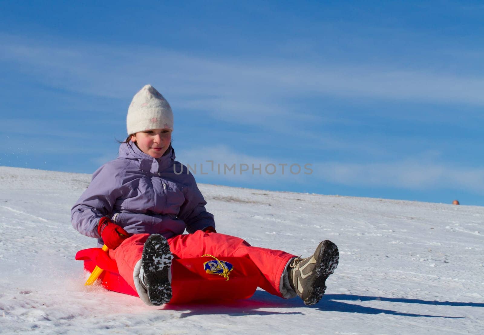 A girl sliding in the snow