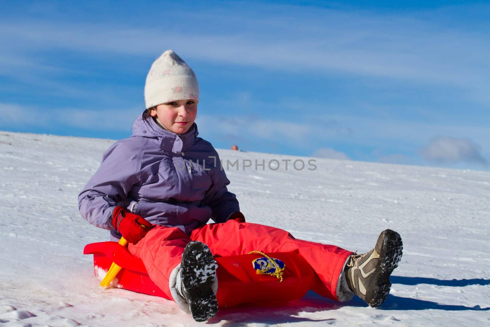 A girl sliding in the snow