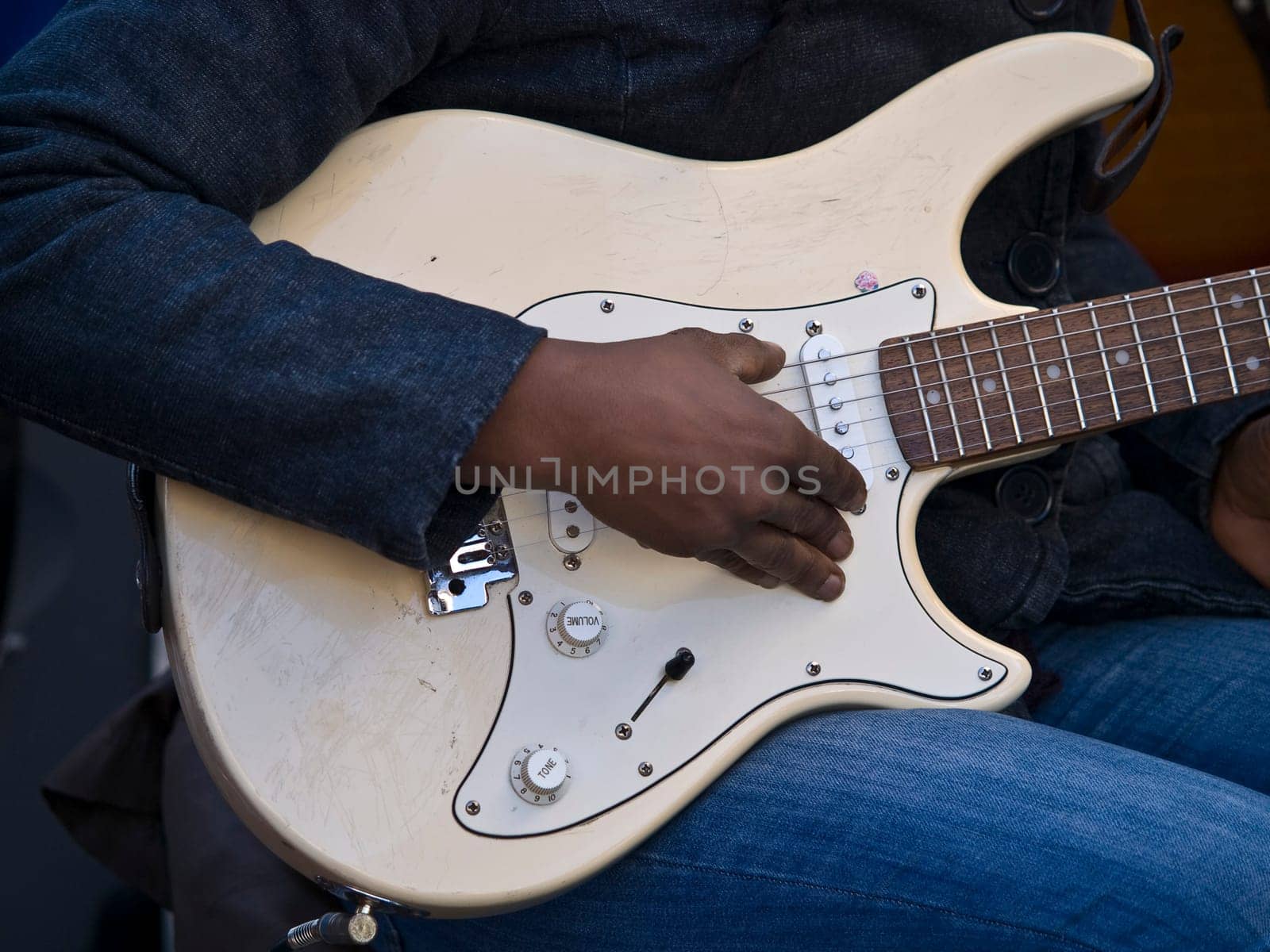 hand of guitar player on the street