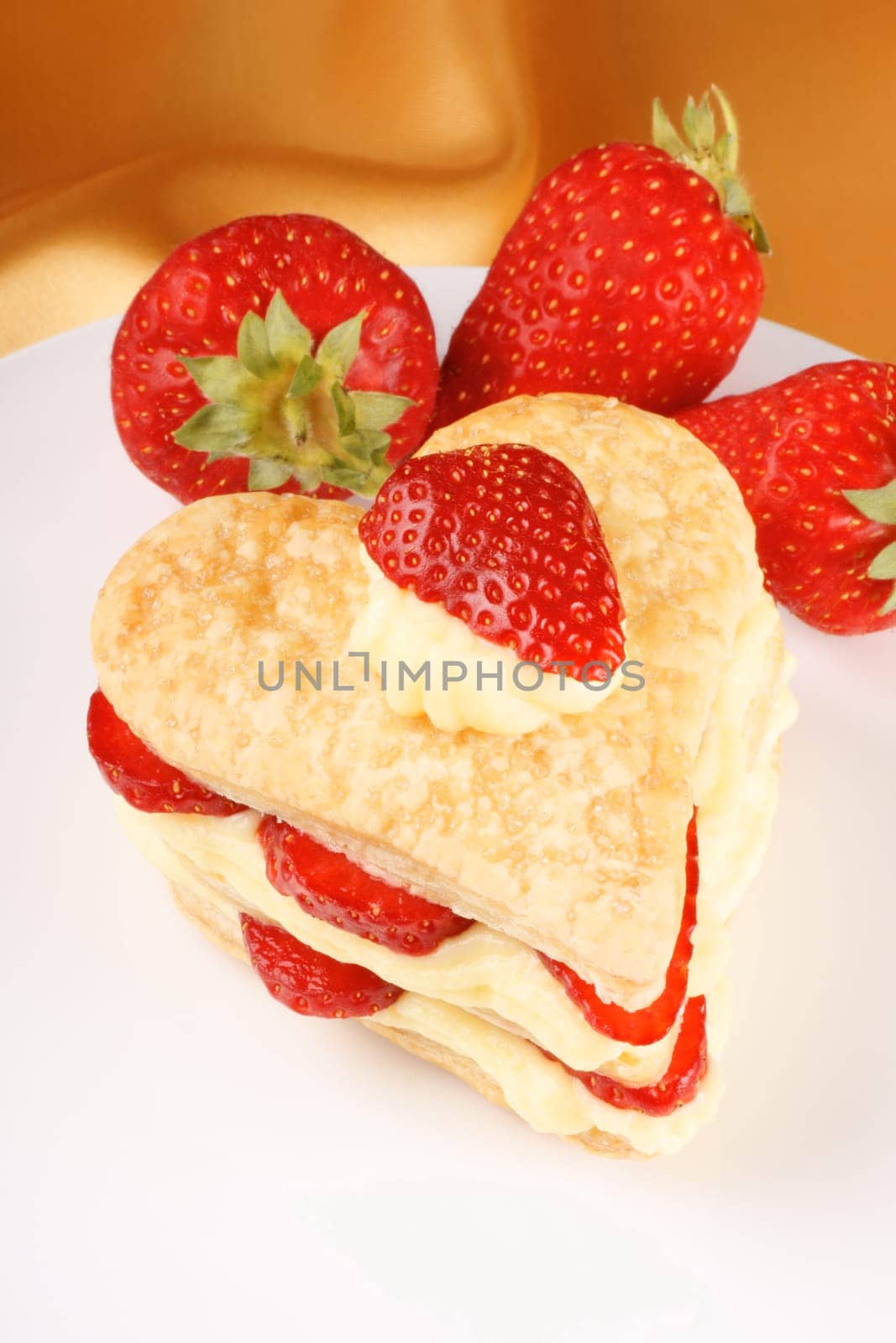 Heart shaped strawberries and custard millefeuille for a sweet Valentine&#039 s Day. Selective focus.