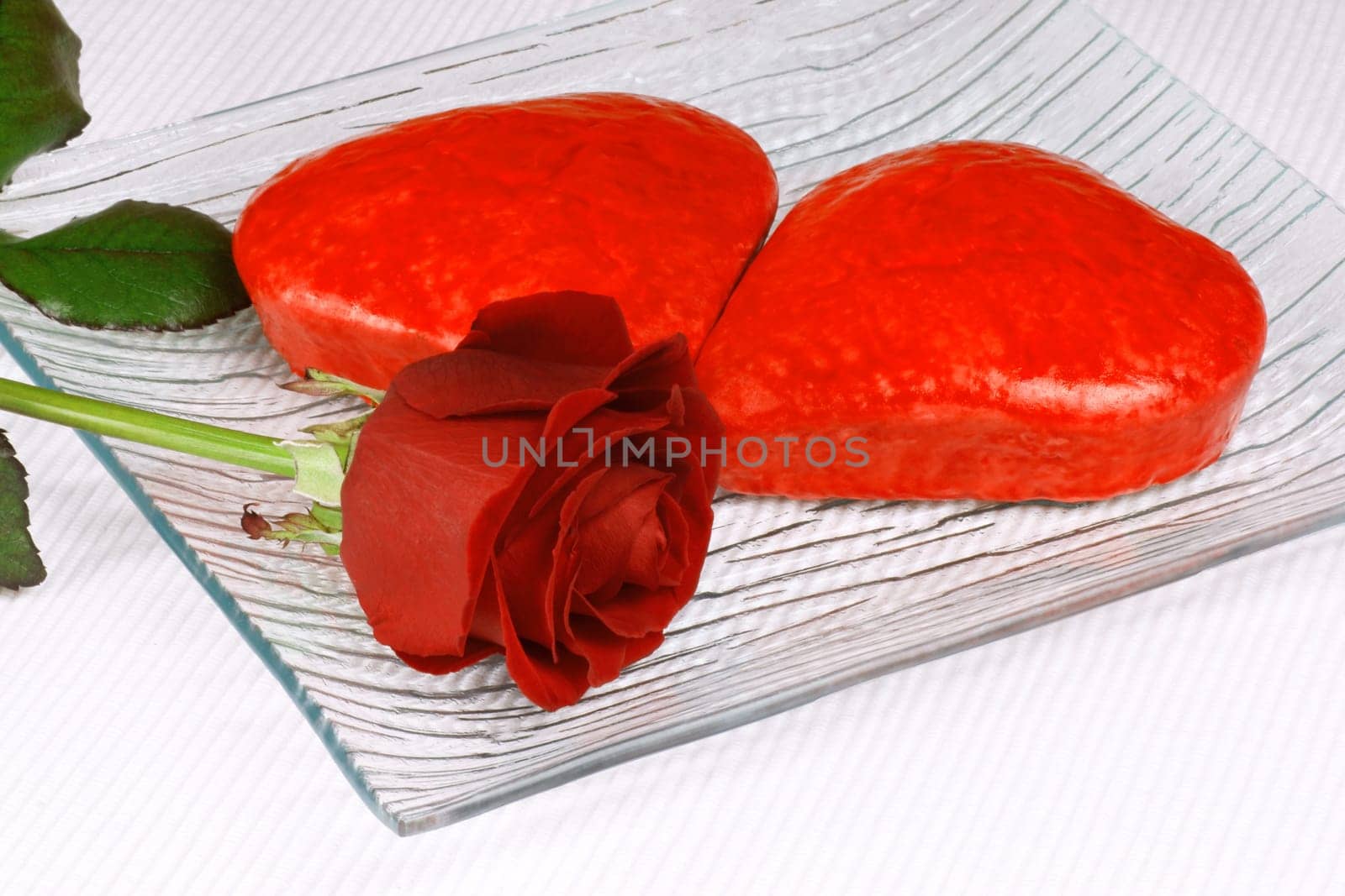 Two red heart shaped cakes and a rose for Valentine&#039 s Day